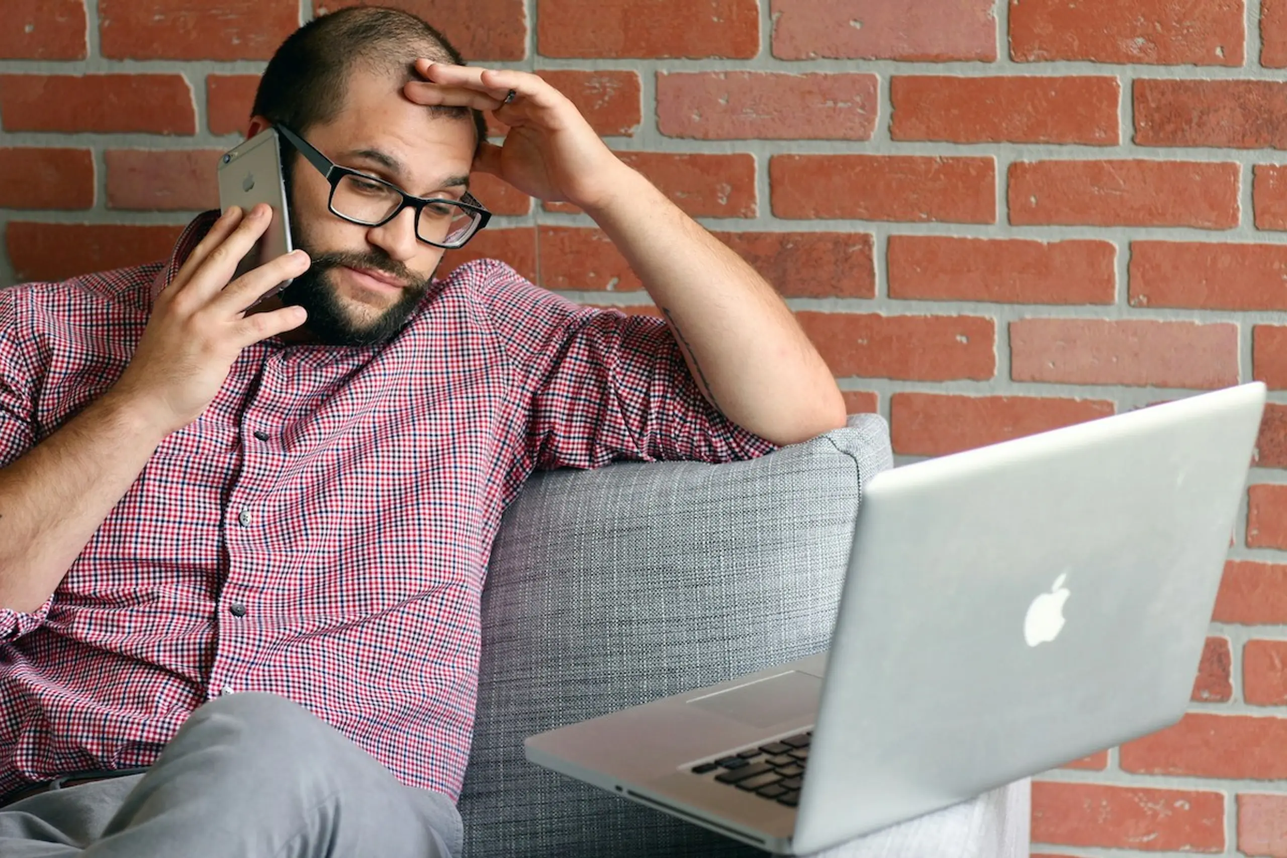 A man on the phone and the computer