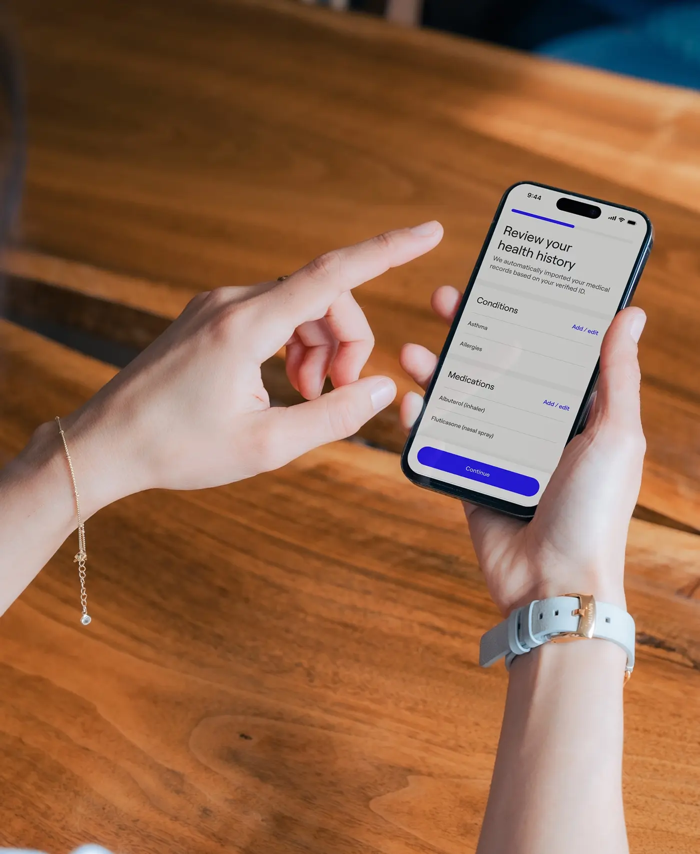 Image of a woman holding an iphone with the General Medicine app on it