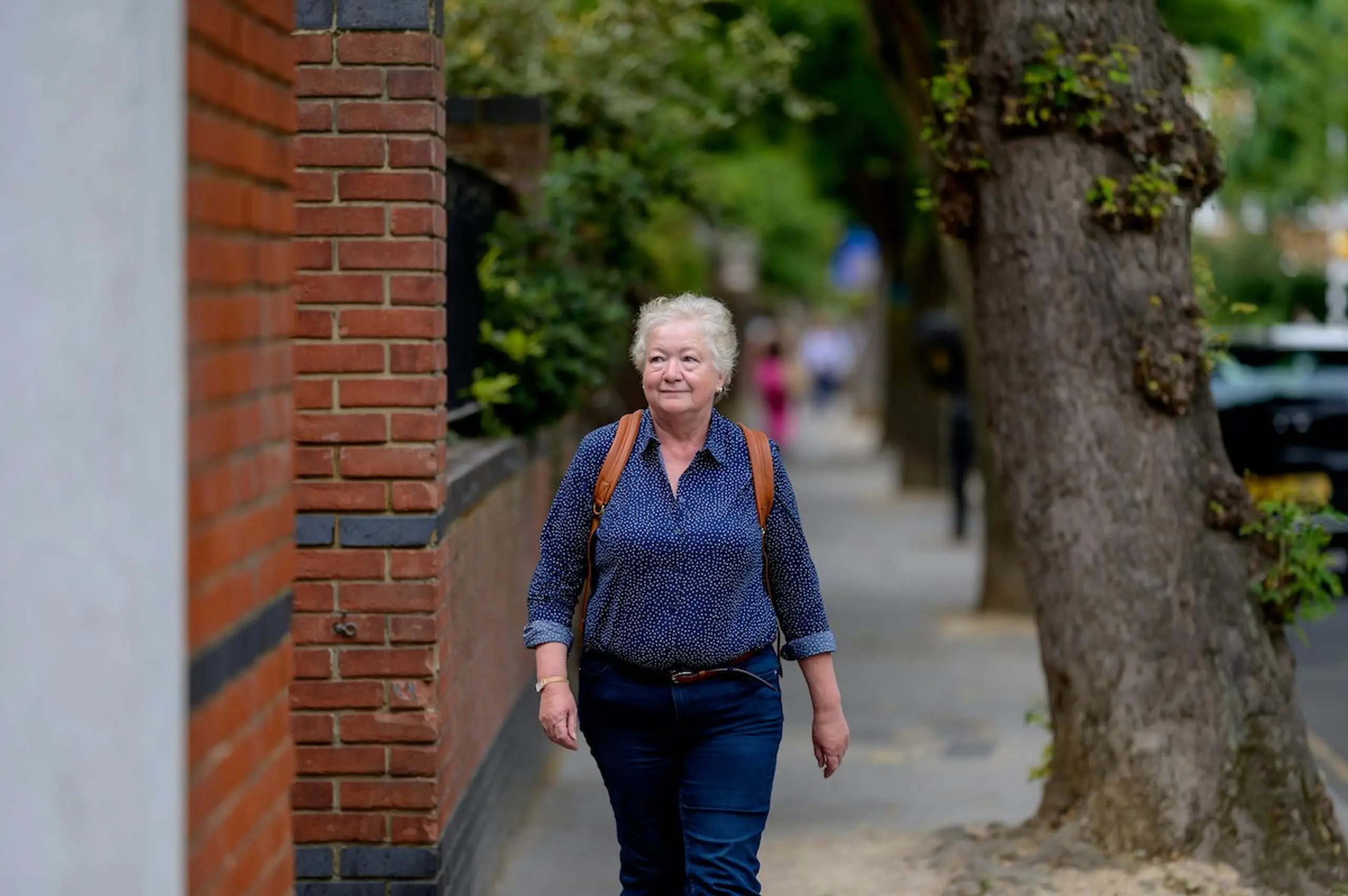 An older person walking outside