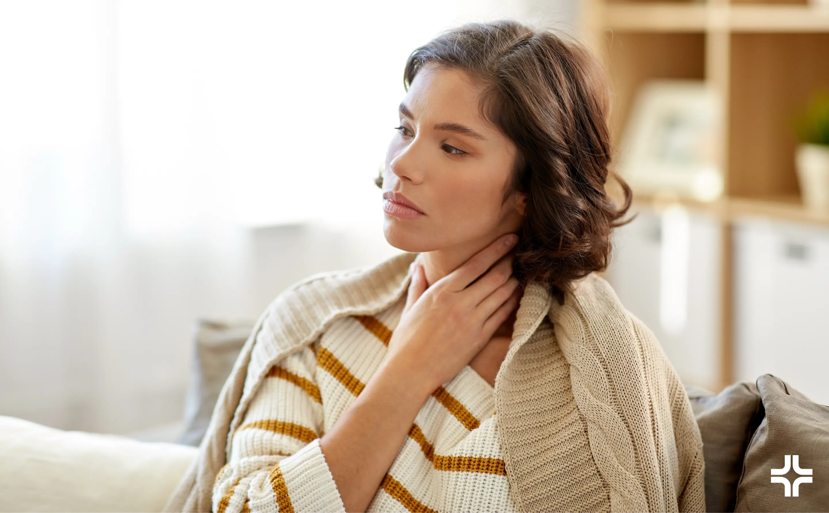 Woman holding throat in discomfort