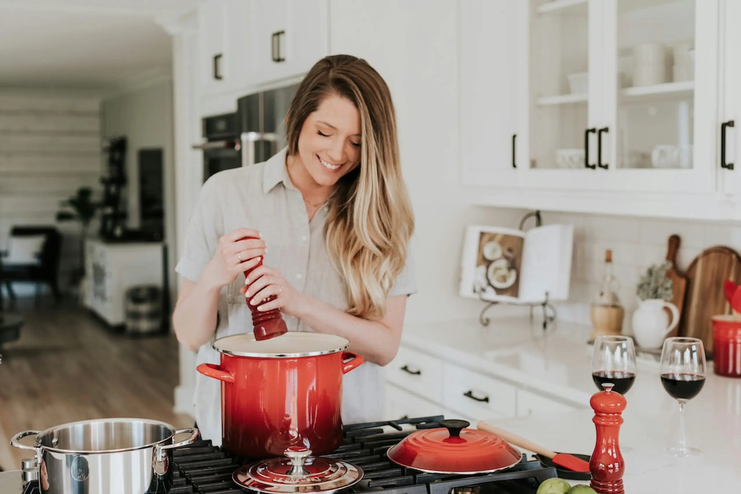 woman cooking in kitchen with orange pots