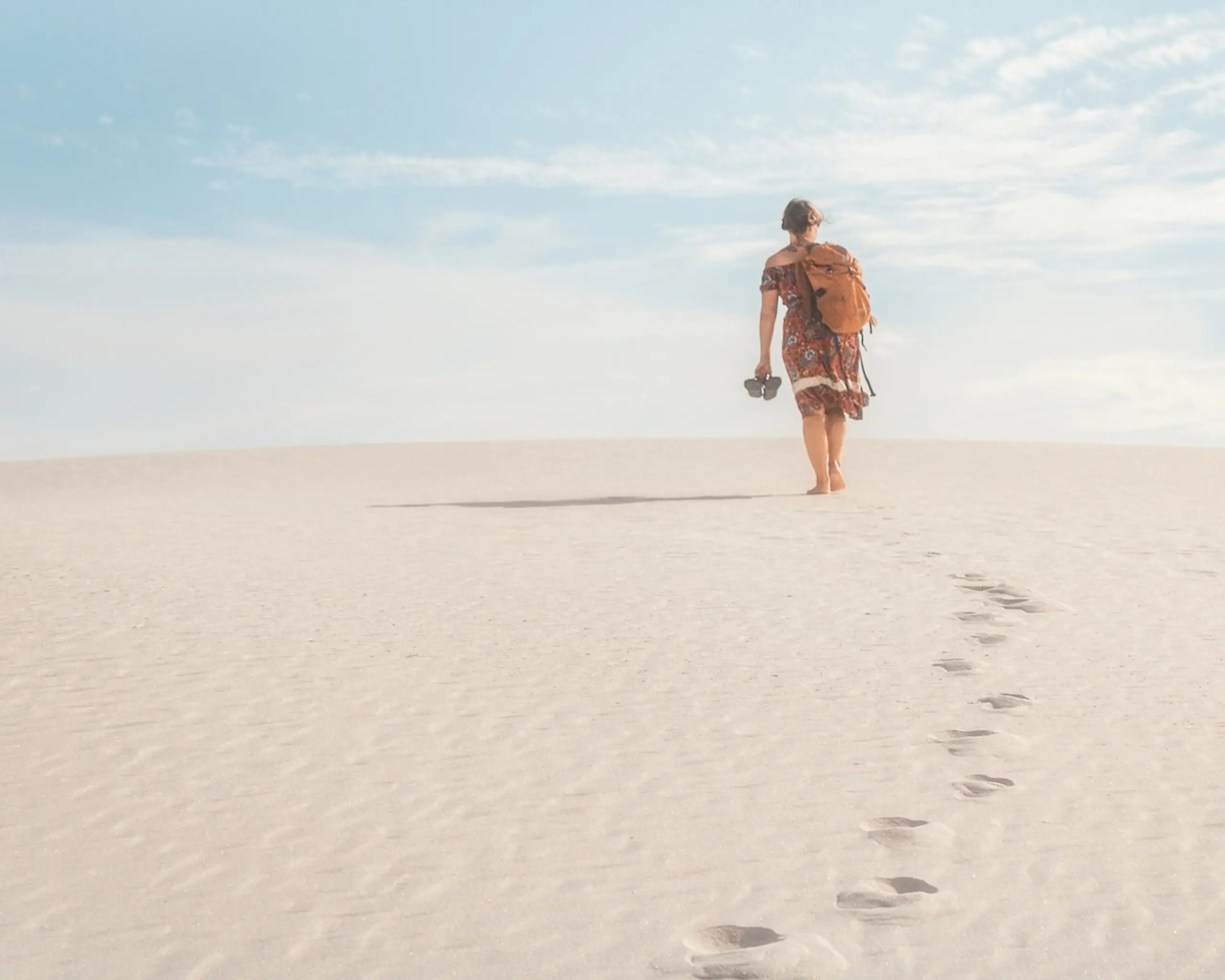 woman walking on beach in sand