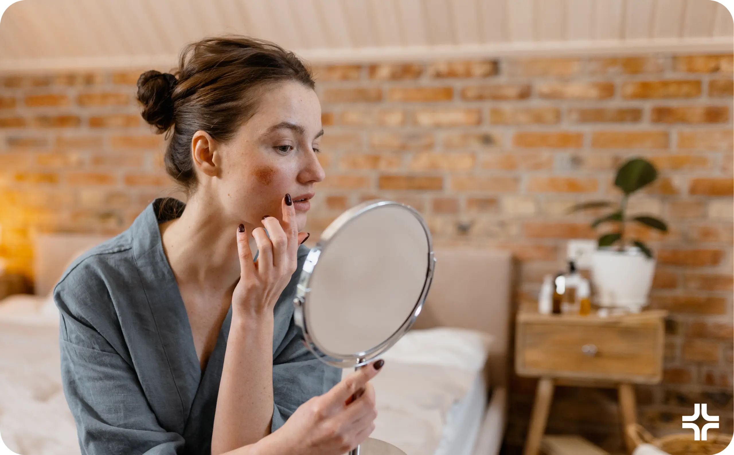 Woman looks in mirror and touches face