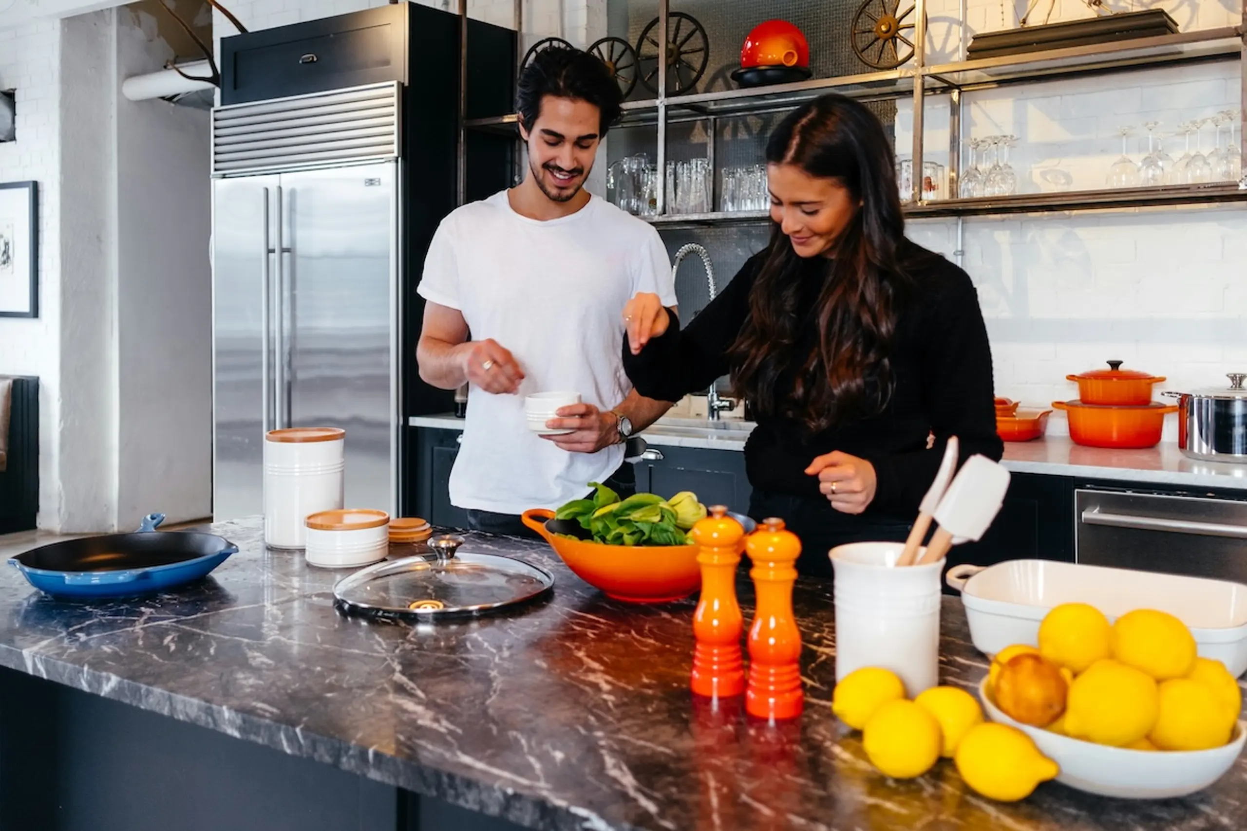 man and woman cooking in kitchen