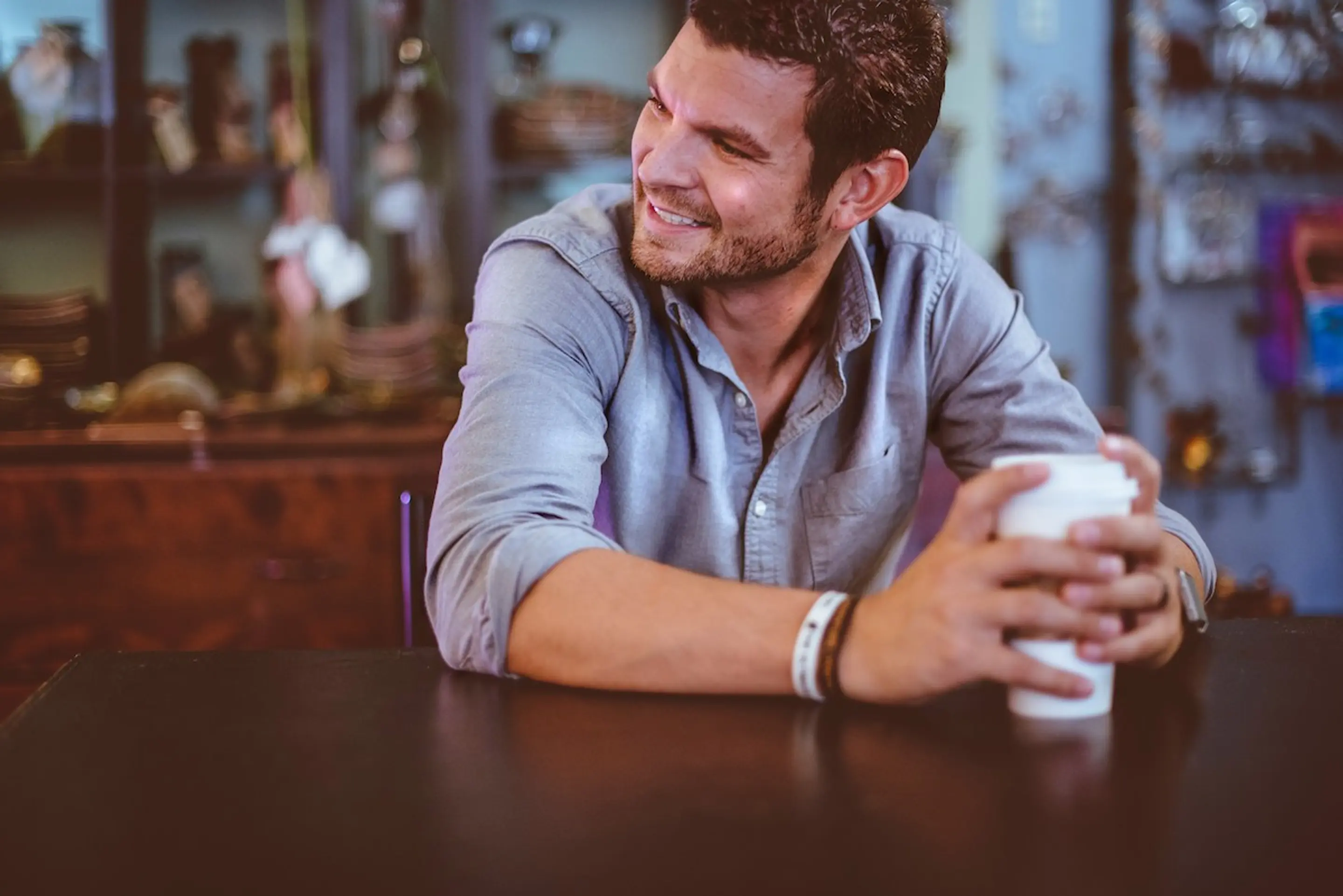 A man with a coffee at a cafe