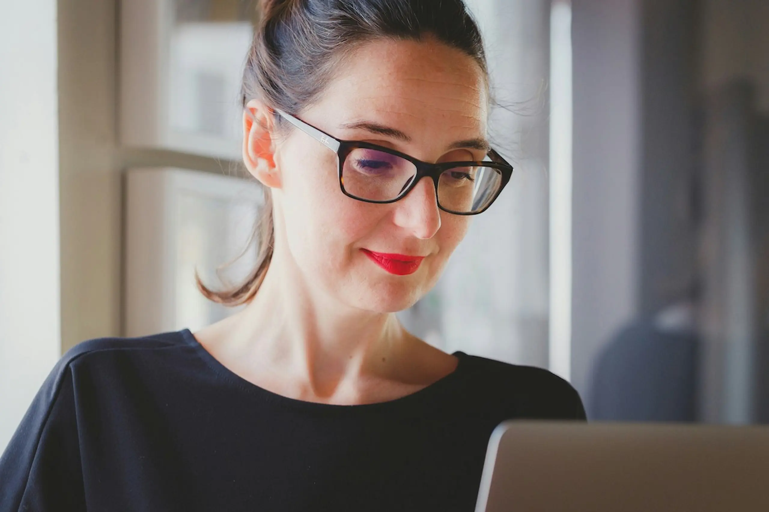 A woman reading on the computer