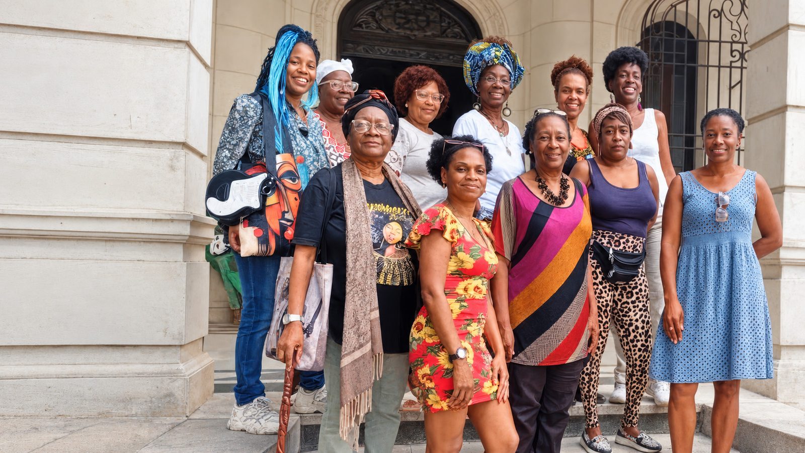 A group of women gathered outside a building during an AltruVistas journey.