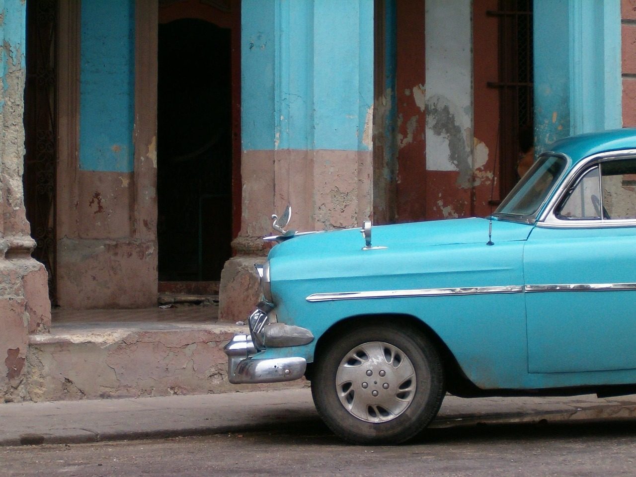 A vintage blue car parked on a Havana street in Cuba