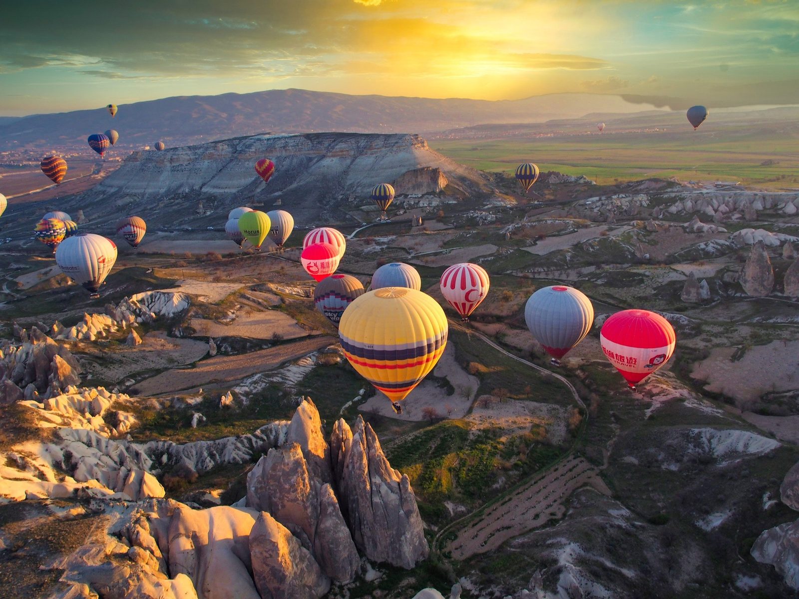 Hot air balloons over land formations in Cappadocia, Turkey