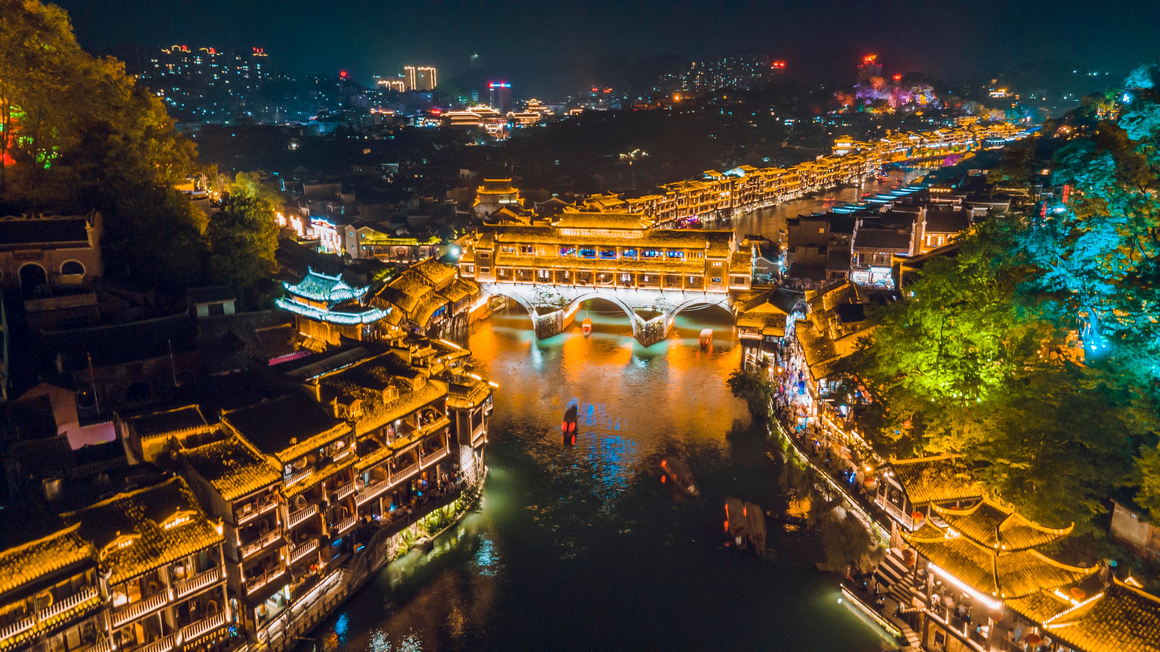Immerse in Fenghuang Ancient Town's riverside night views and enjoy an exclusive VIP experience: Miao costume dressing and aerial video shooting for unique memories.