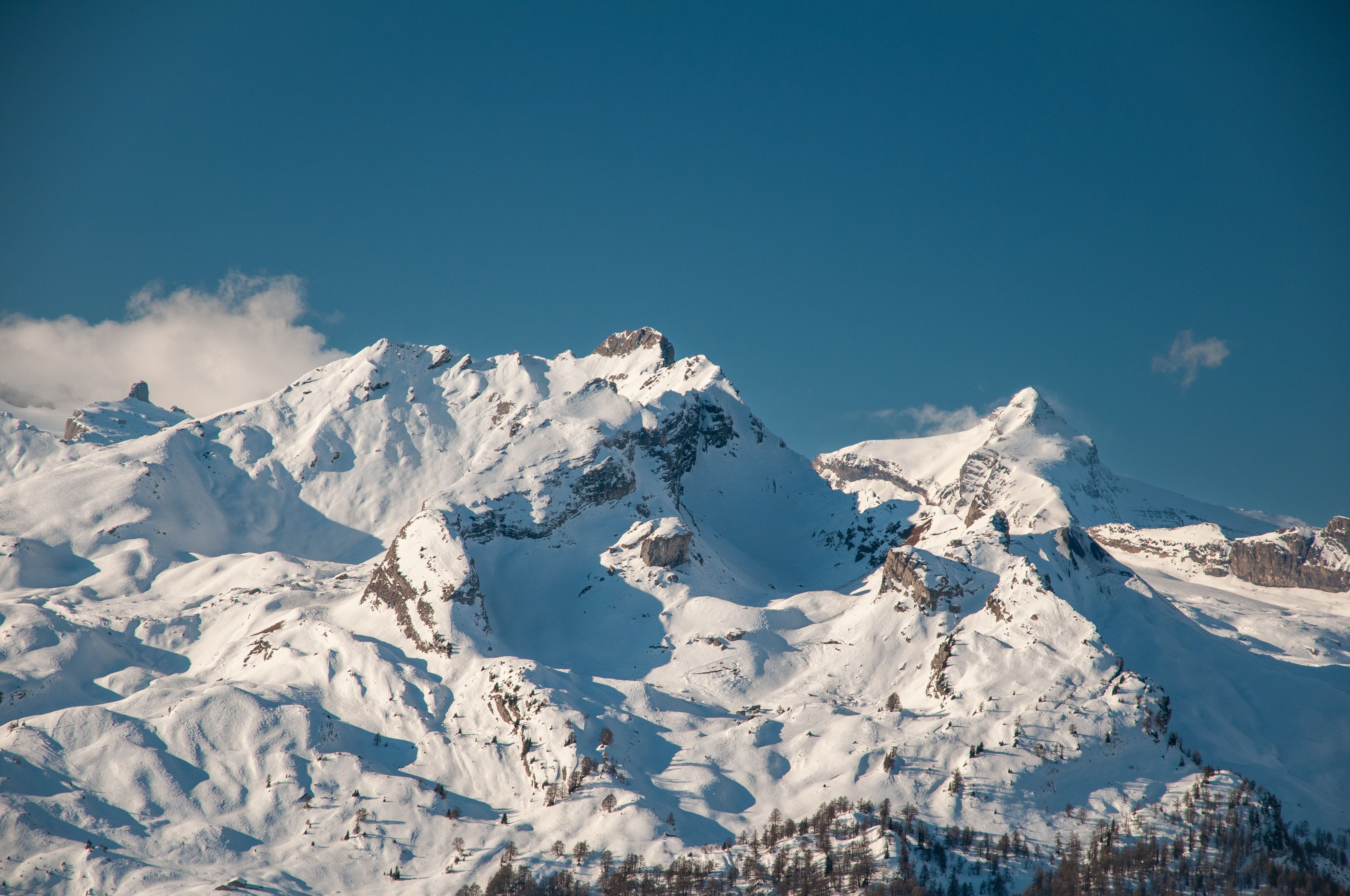 Snow-covered Alpine peaks beneath a clear sky