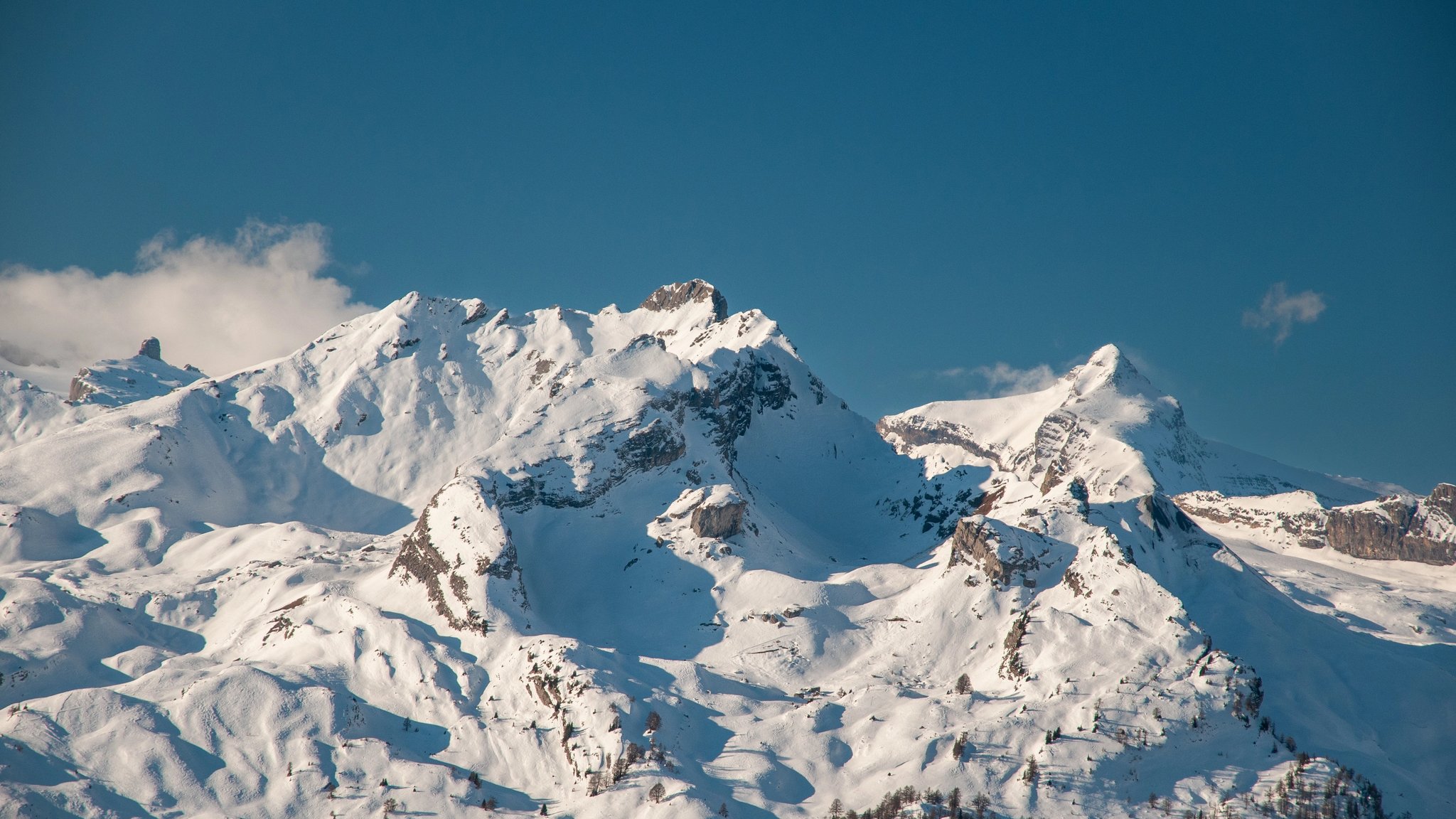 Snow-covered Alpine peaks beneath a clear sky