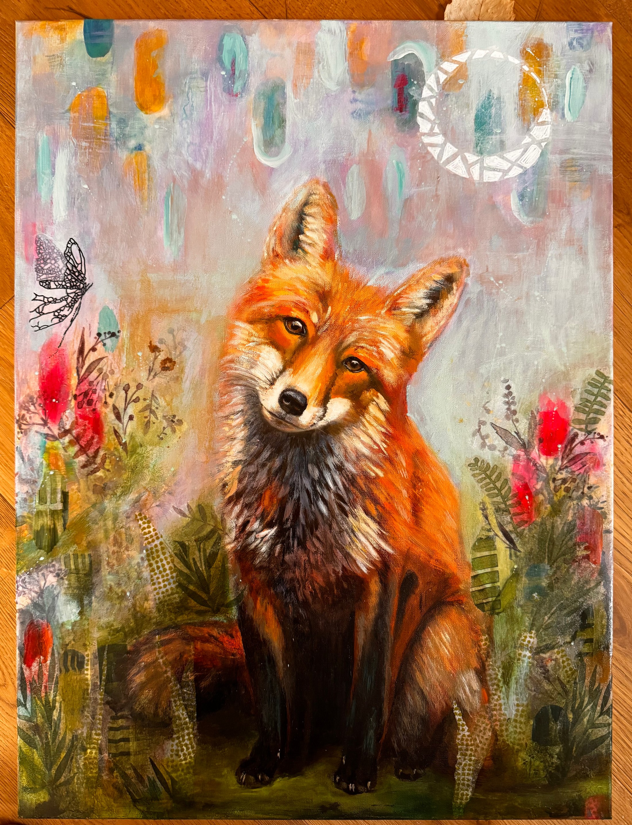 Red fox seated amid ferns and bright wildflowers beneath floating pastel shapes and a pale spiral moon.