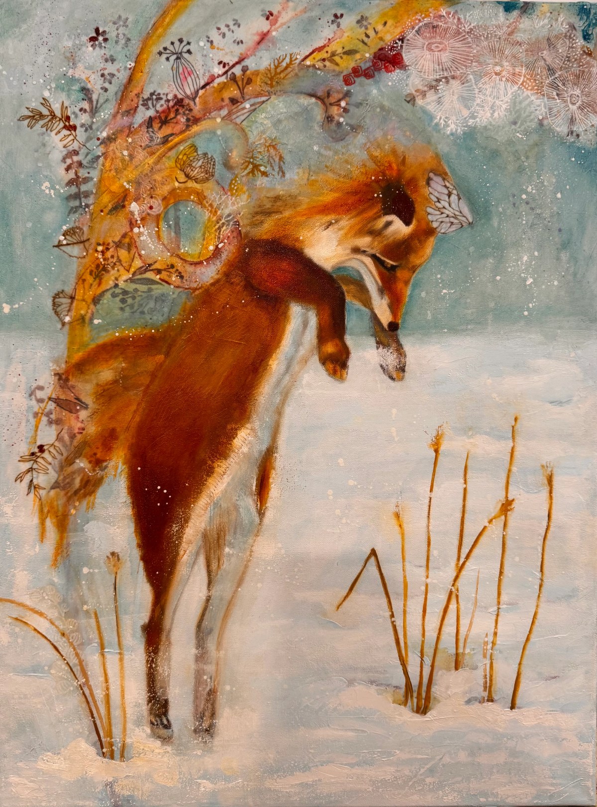 Red fox leaping headfirst into snow beneath a sweeping branch of patterned autumn leaves.