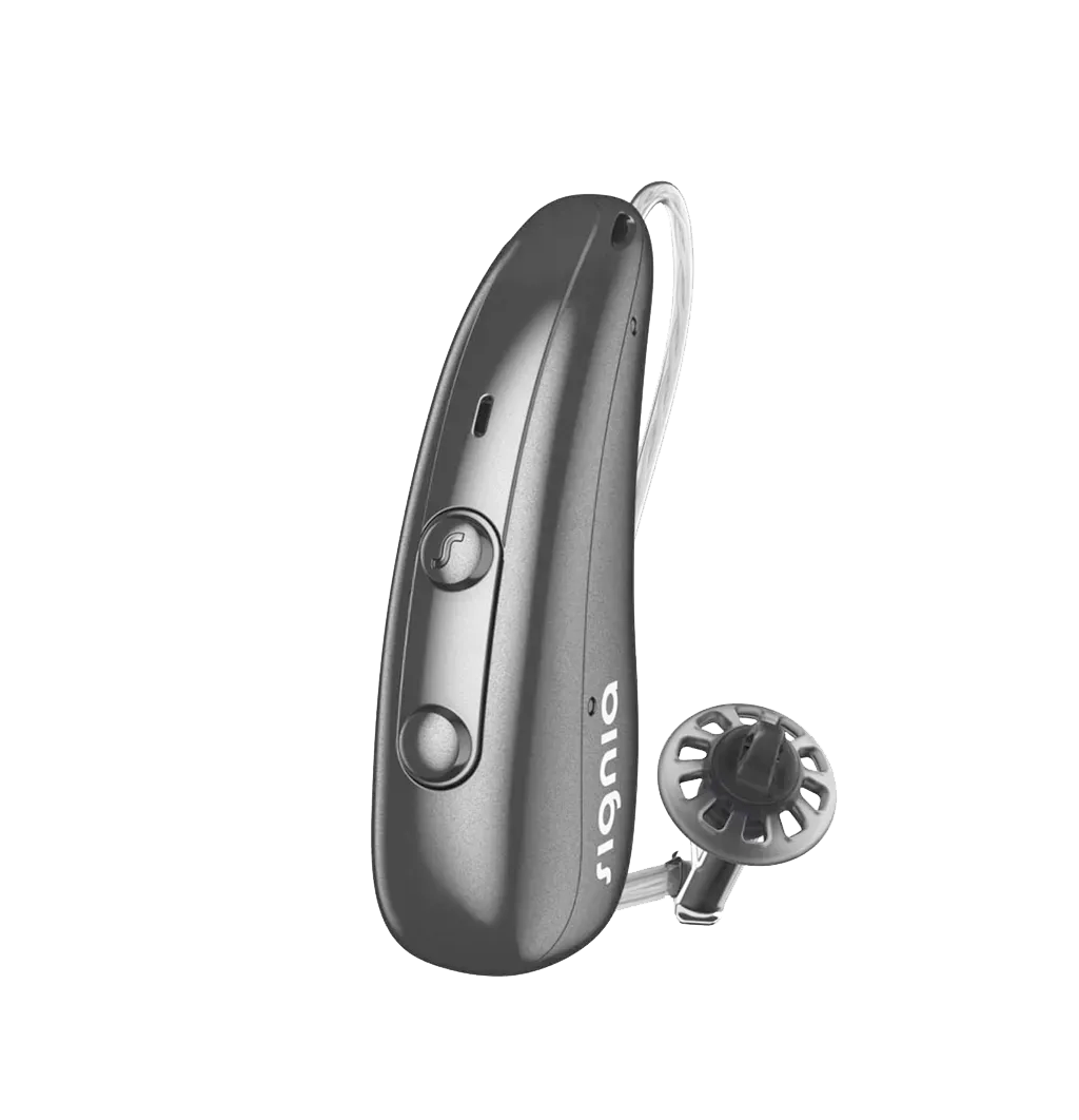 A behind-the-ear hearing aid being fitted over a patient’s ear at the Dripping Springs office