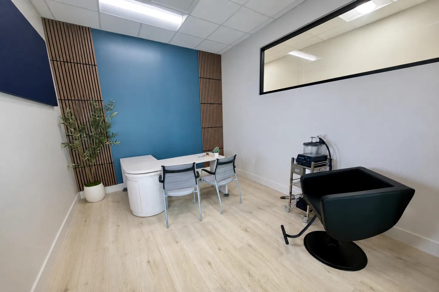 The earwax removal room at the Dripping Springs office, with the Earigator system ready beside the chair
