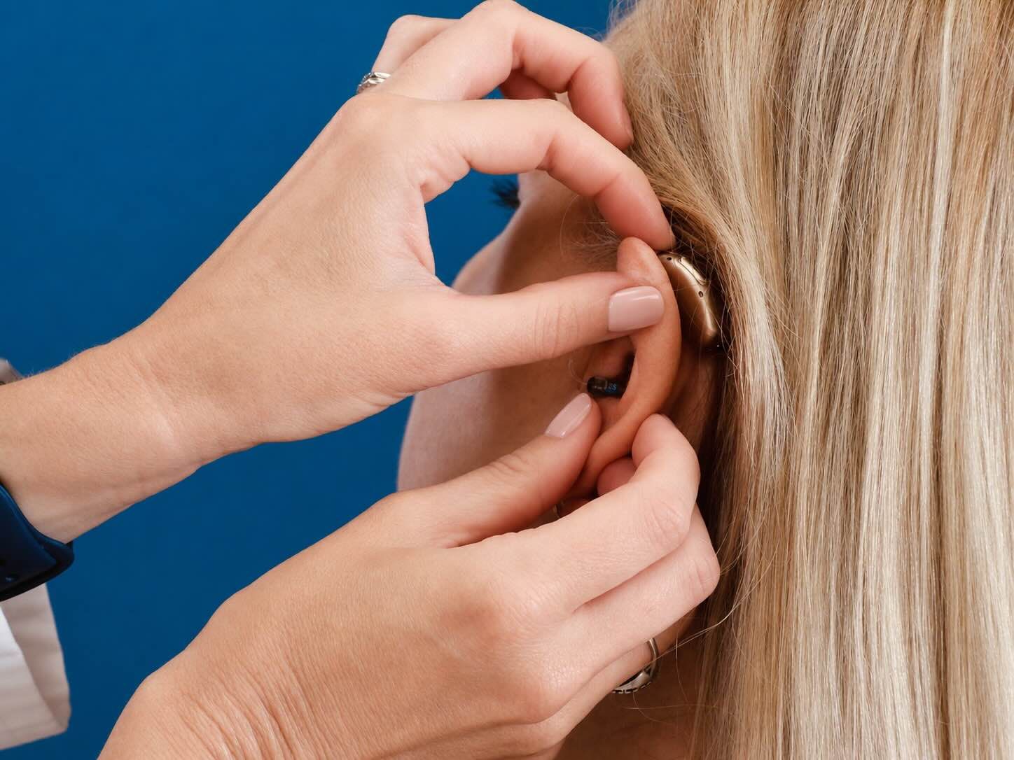 Dr. Paige Juarez doing a hearing aid fitting
