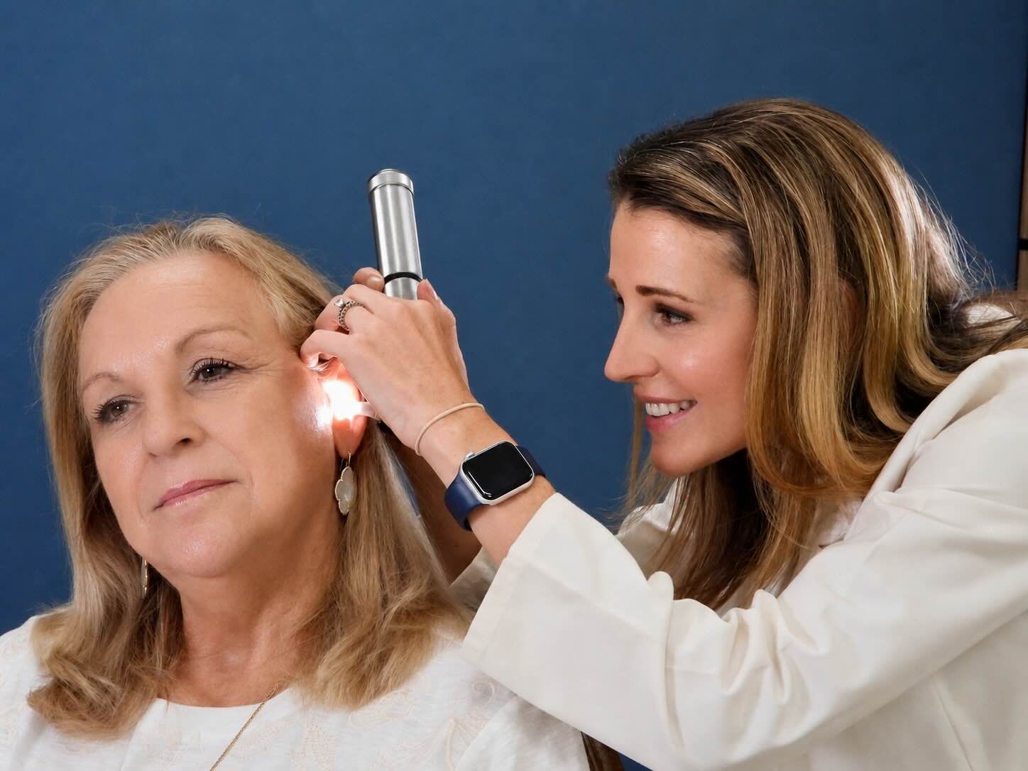Dr. Paige Juarez checking patient's ear