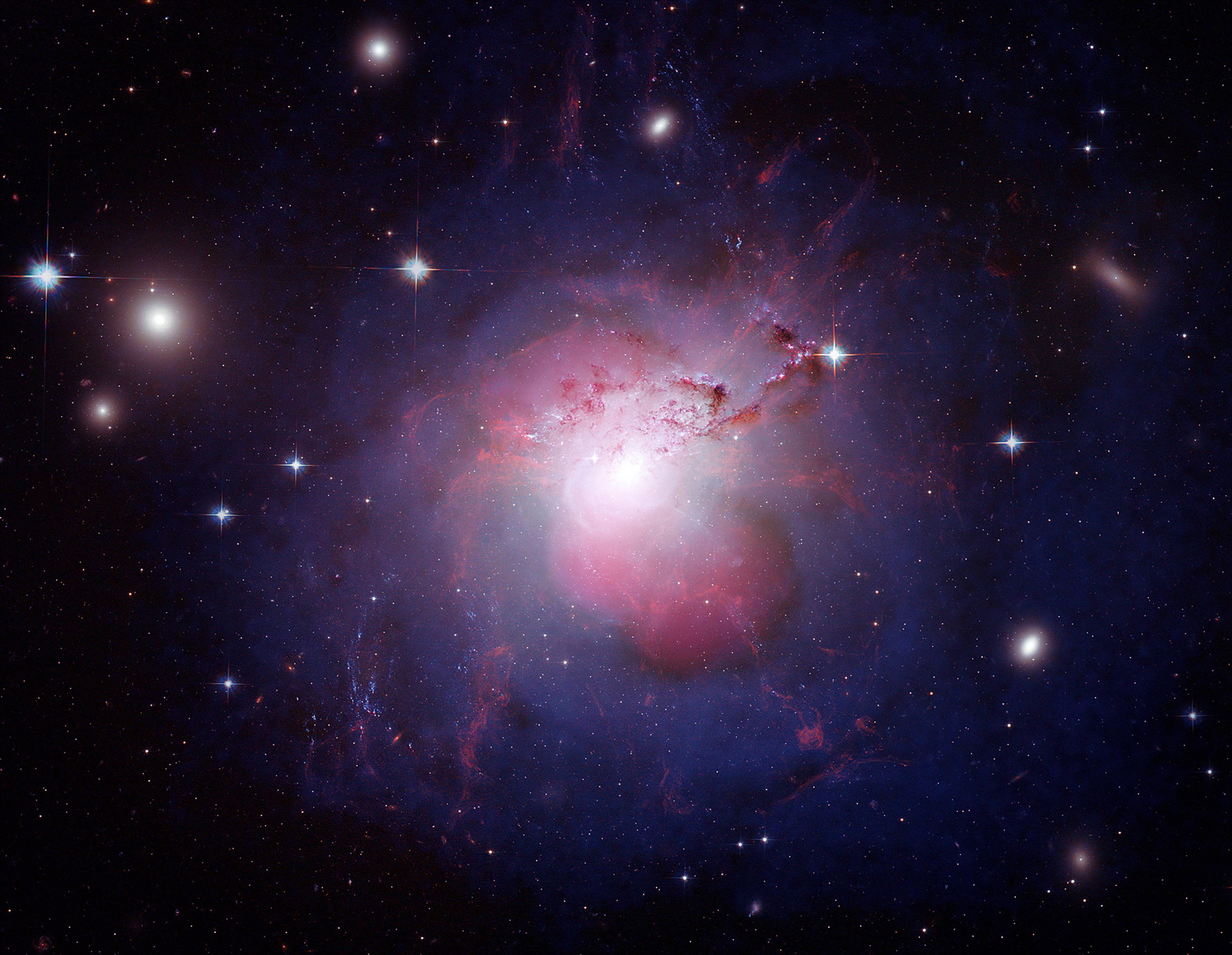 The active galaxy NGC 1275 is a well-known radio source (Perseus A) and a strong emitter of X-rays due to the presence of a black hole in the center of the galaxy. Credit: X-ray: NASA/CXC/IoA/A.Fabian et al.; Radio: NRAO/VLA/G. Taylor; Optical: NASA/ESA/Hubble Heritage (STScI/AURA) & Univ. of Cambridge/IoA/A. Fabian 