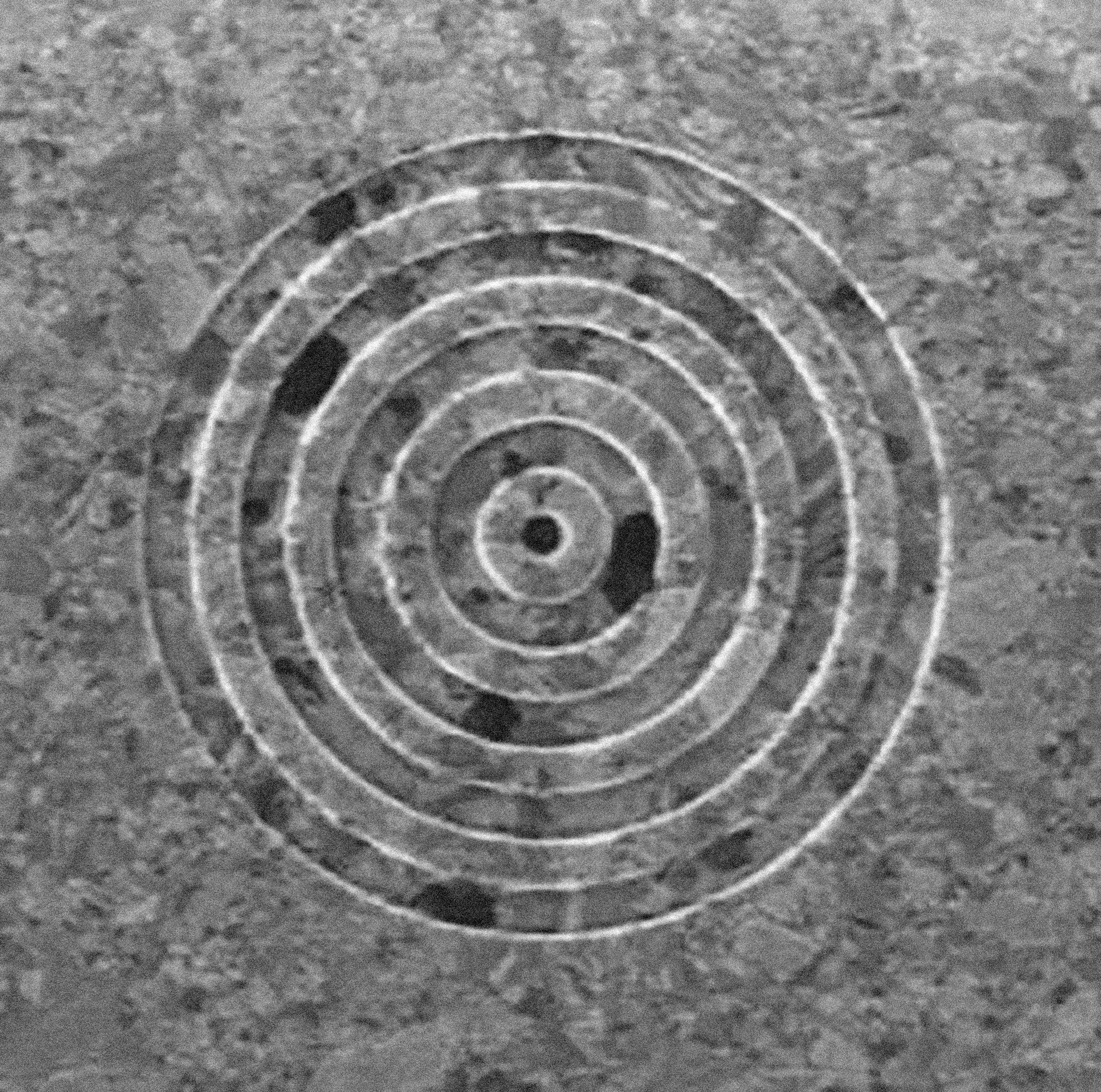 Focused ion beam micrograph image of the bull’s eye structure on a 300 nm-thick silver film used to demonstrated transmission through a subwavelength hole