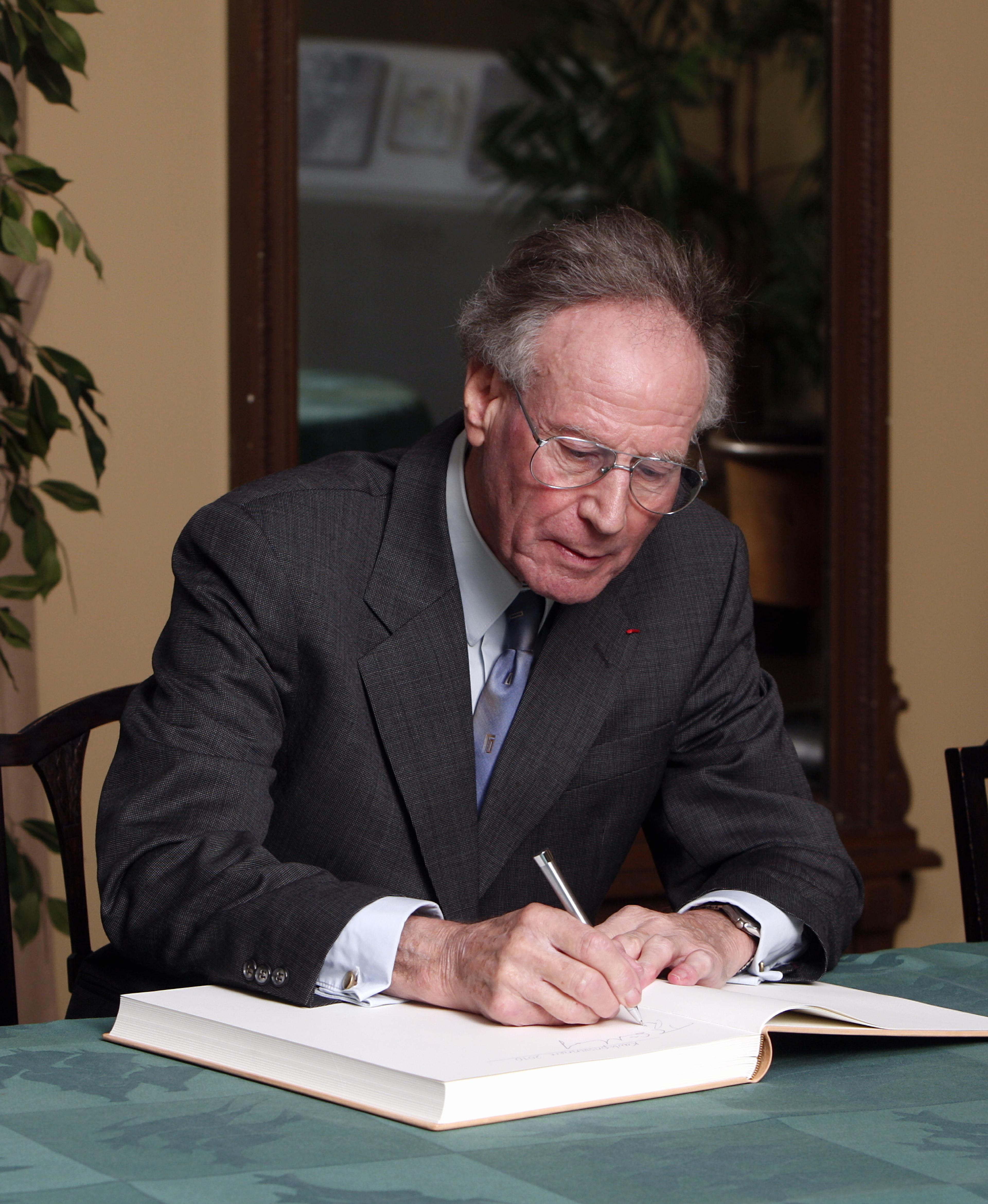 Raymond N. Wilson signing the guest book