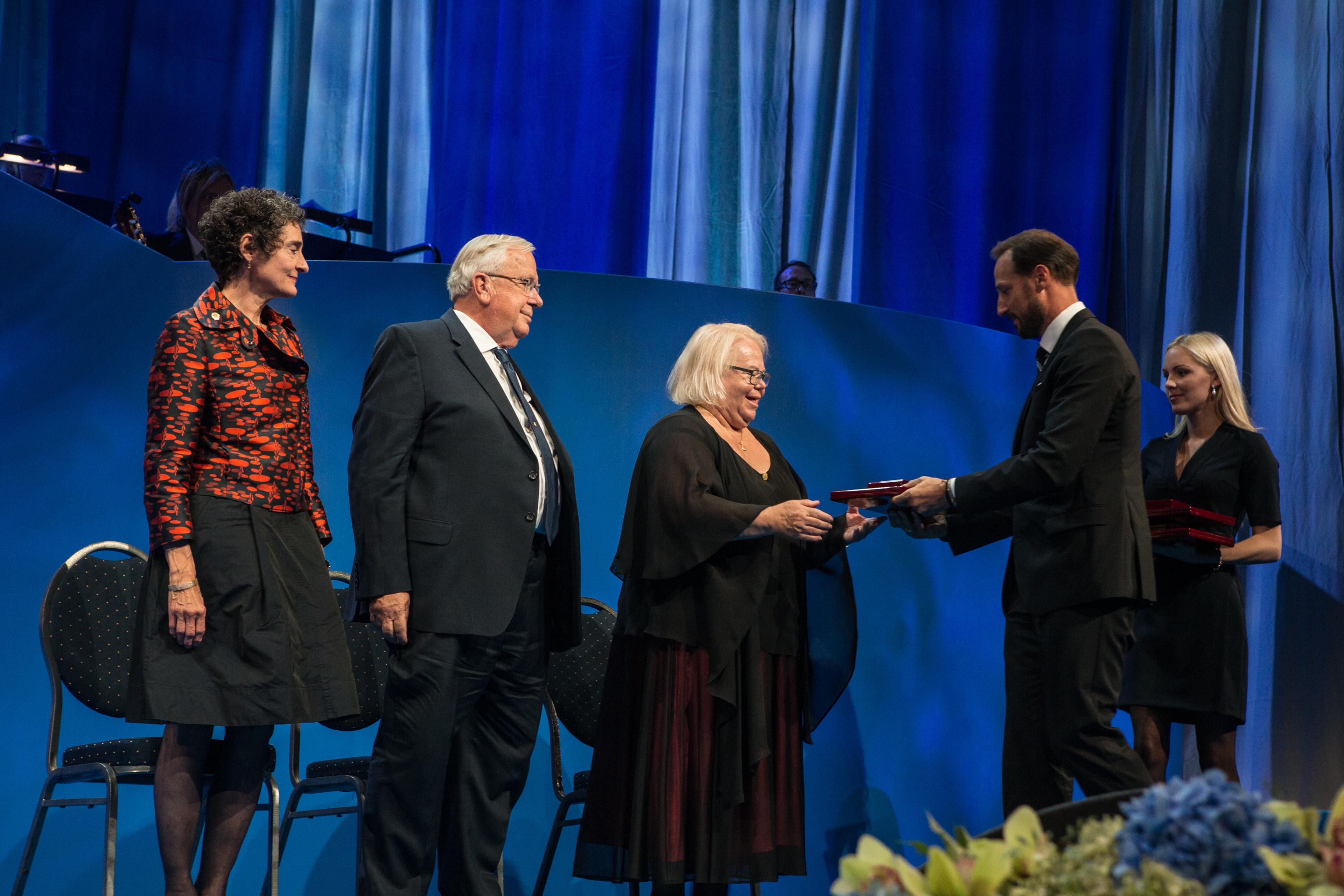 The three neuroscience laureates on stage at the ceremony in Oslo receiving their awards; from left: Carla J. Shatz, Michael M. Merzenich, Eve Marder and His Royal Highness Crown Prince Haakon 