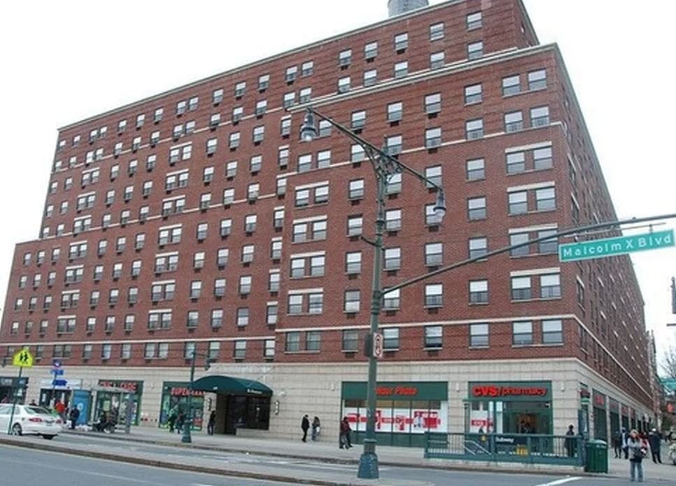 Exterior of The Renaissance, a red-brick co-op building at 130 Malcolm X Boulevard in Harlem
