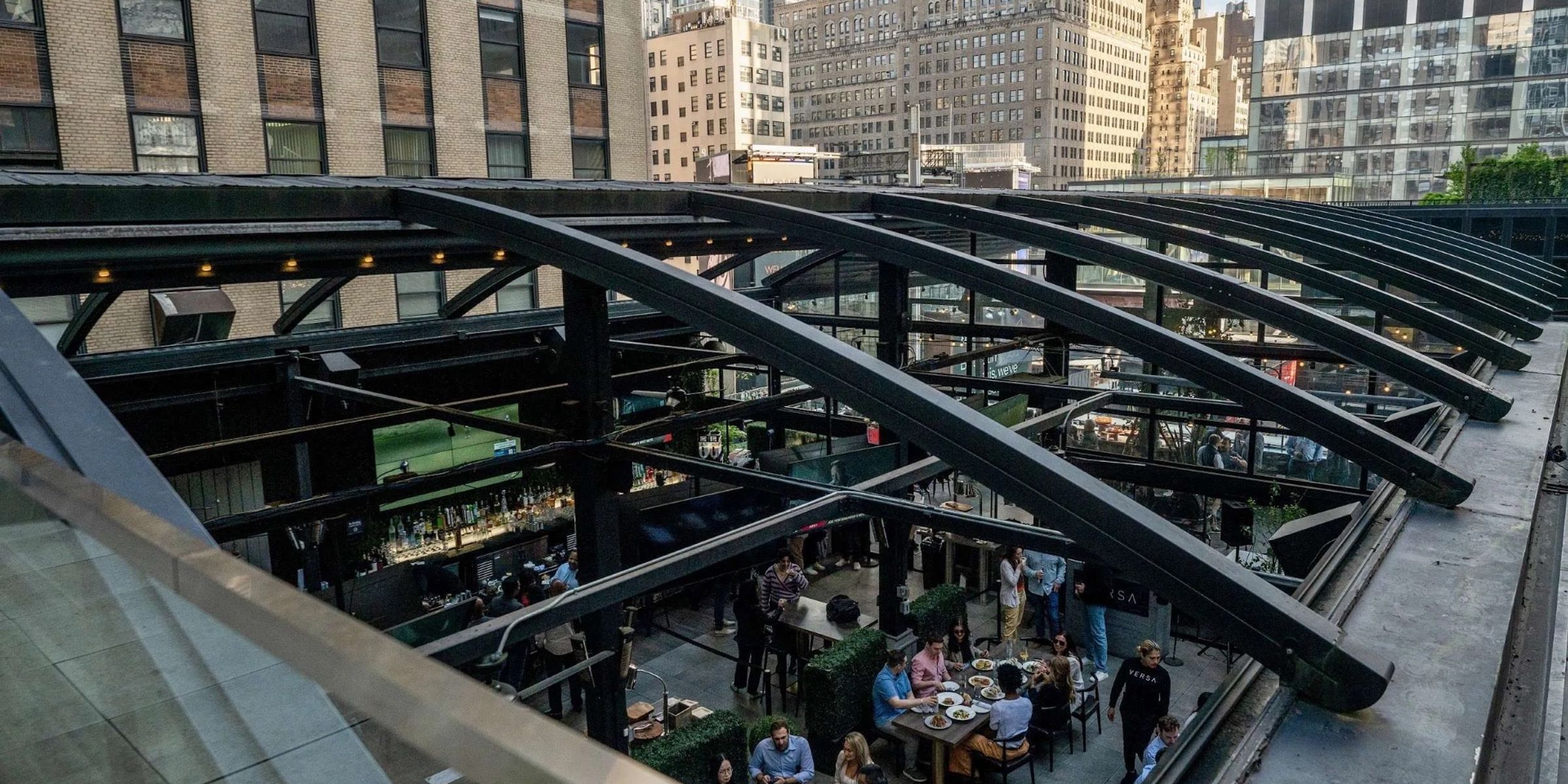Rooftop event space at Versa with the retractable glass roof open above dinner tables
