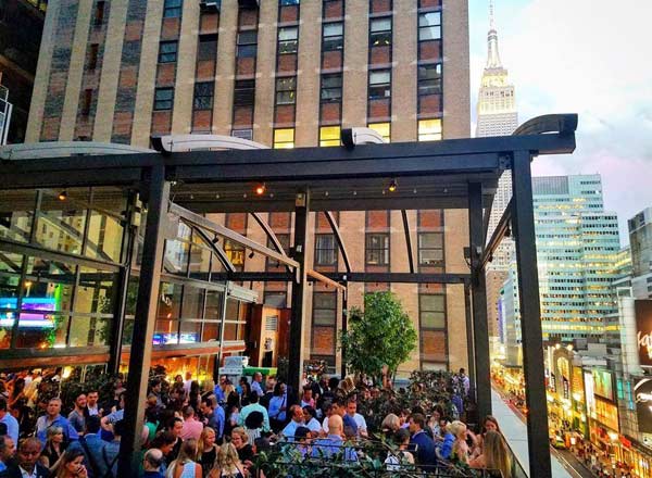 Versa rooftop terrace at dusk with the Empire State Building in view