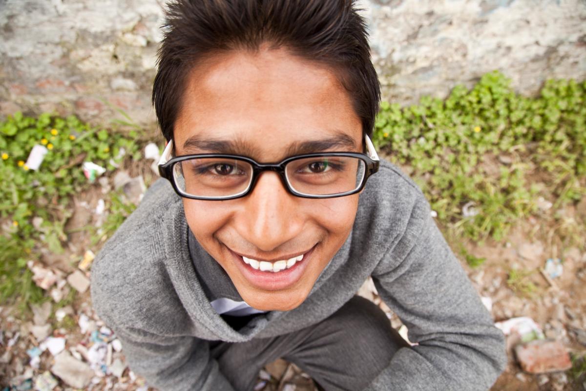 Boy in India smiling with glasses