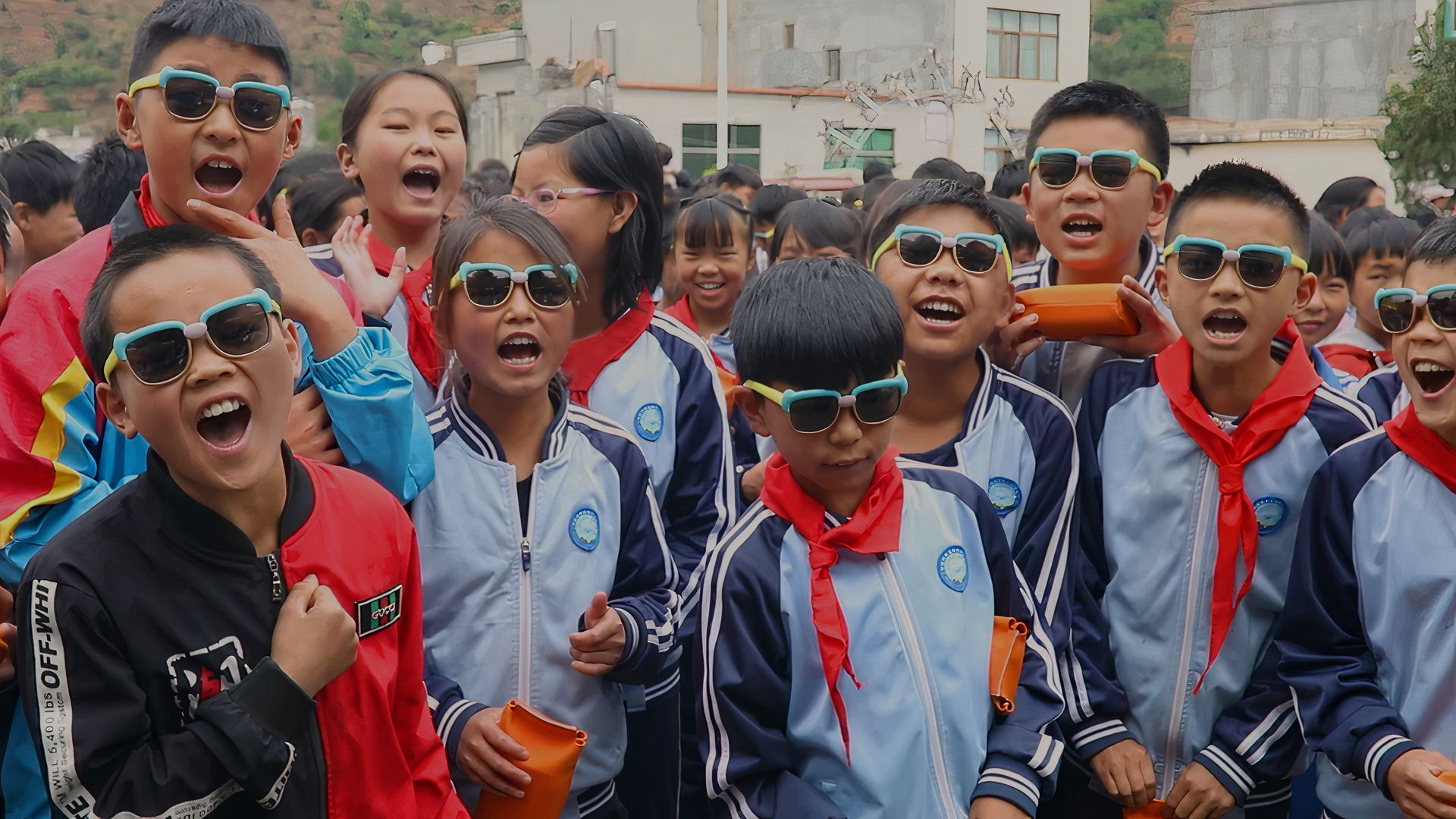 Children in Asia wearing sunglasses and smiling