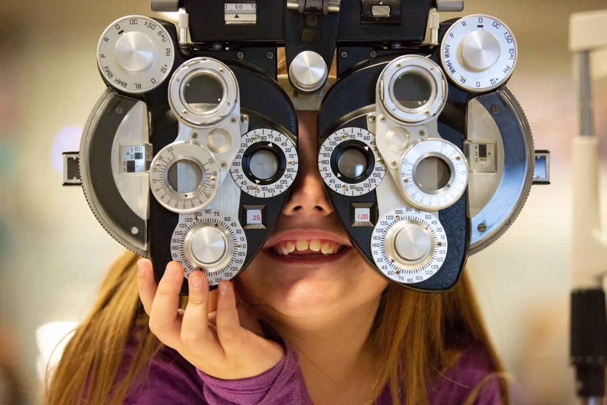 smiling girl getting an eye exam