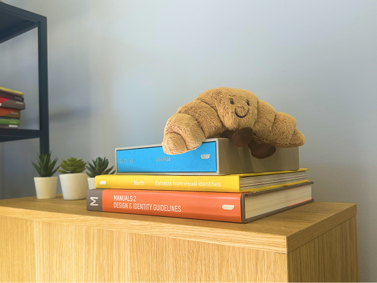 Stack of books on a shelf in the studio