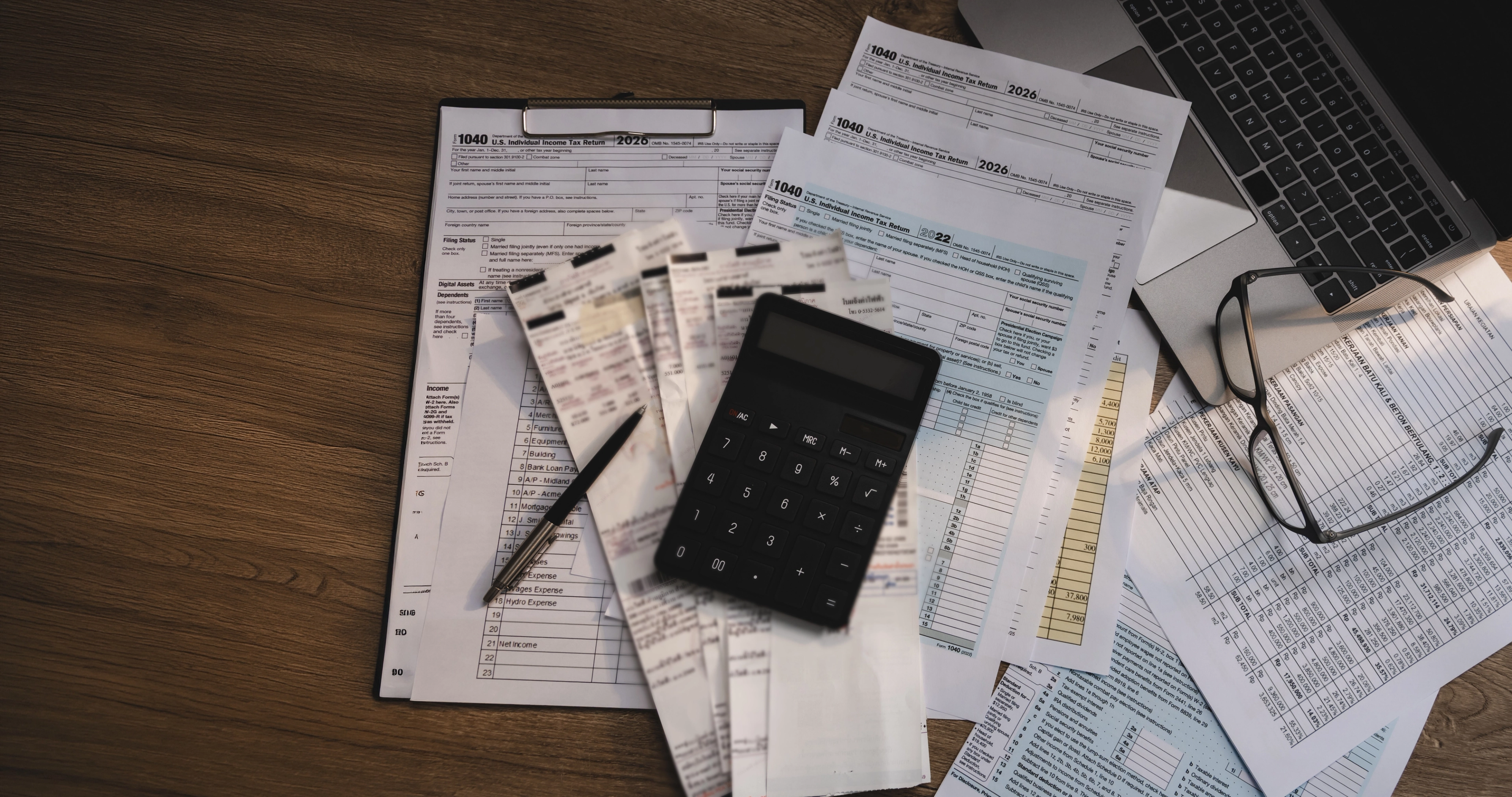 Loan paperwork, calculator and documents on a desk