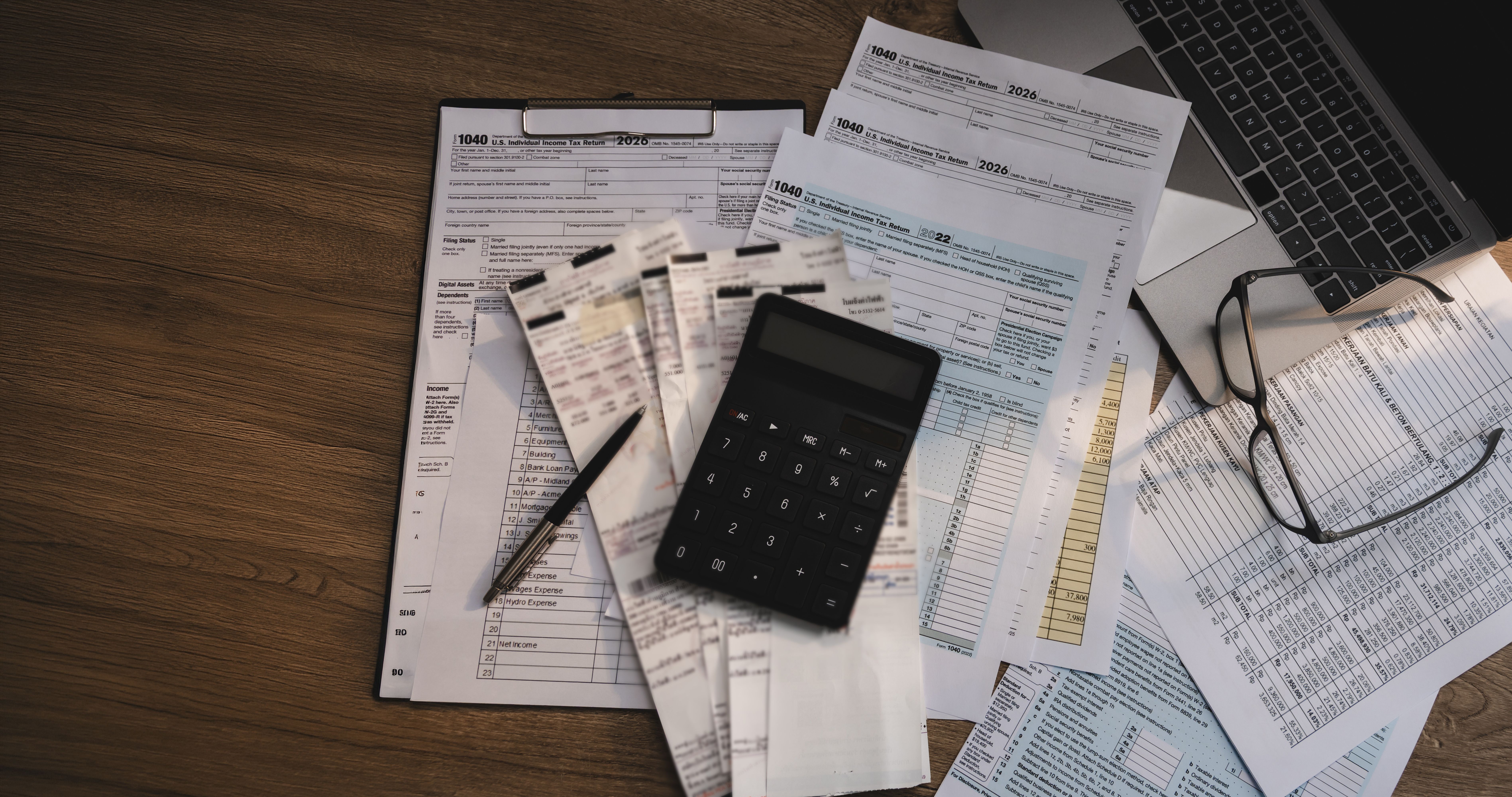 Loan paperwork, calculator and documents on a desk