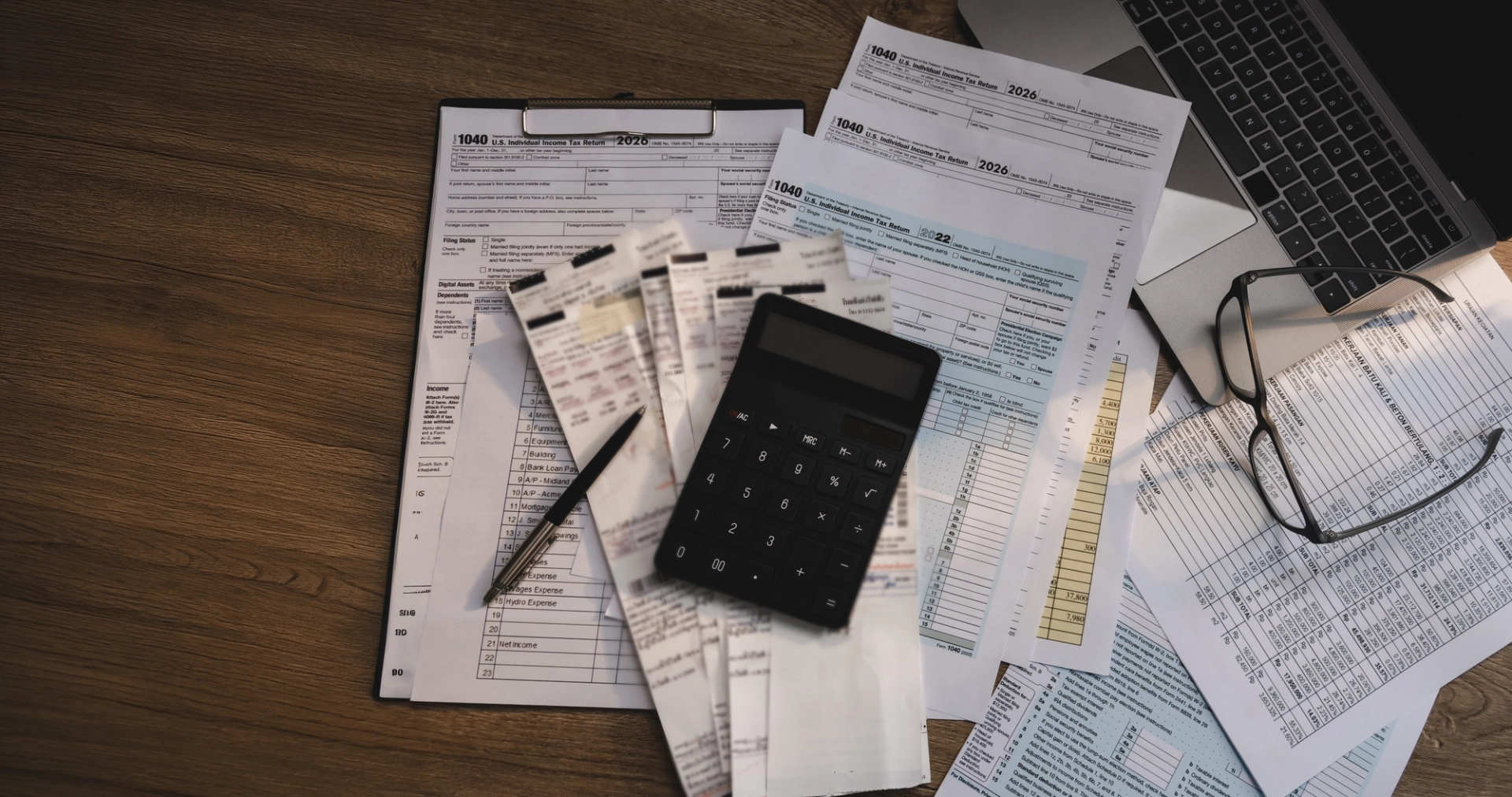 Loan paperwork, calculator and documents on a desk