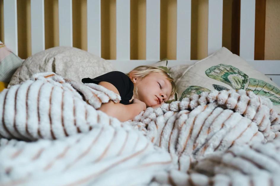 Child sleeping soundly in bed