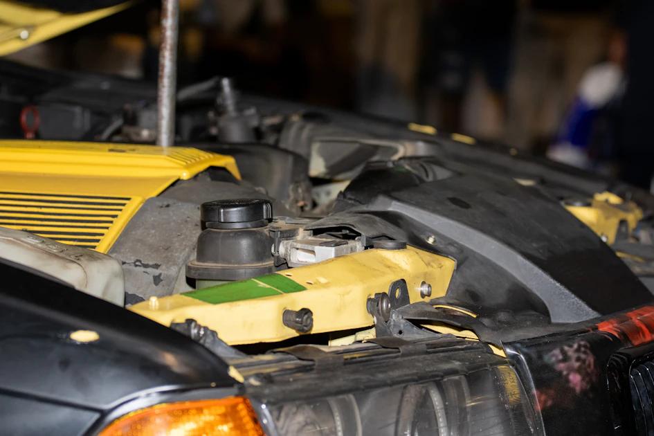 Mechanic inspecting car engine bay