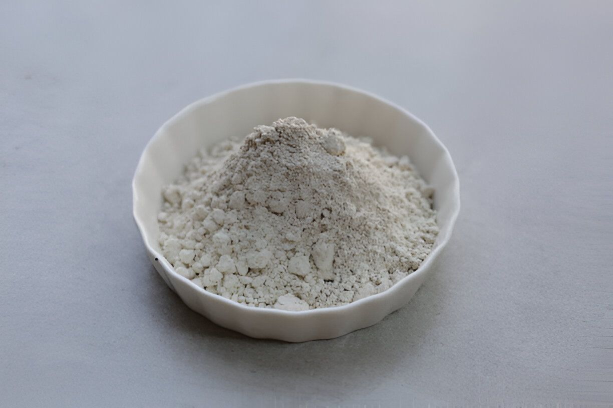 A close-up of a white bowl filled with alumina, emphasizing the material's purity and fine granularity