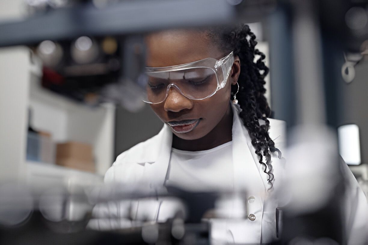 A female researcher analysing data in a laboratory setting, equipped with various scientific tools and apparatus