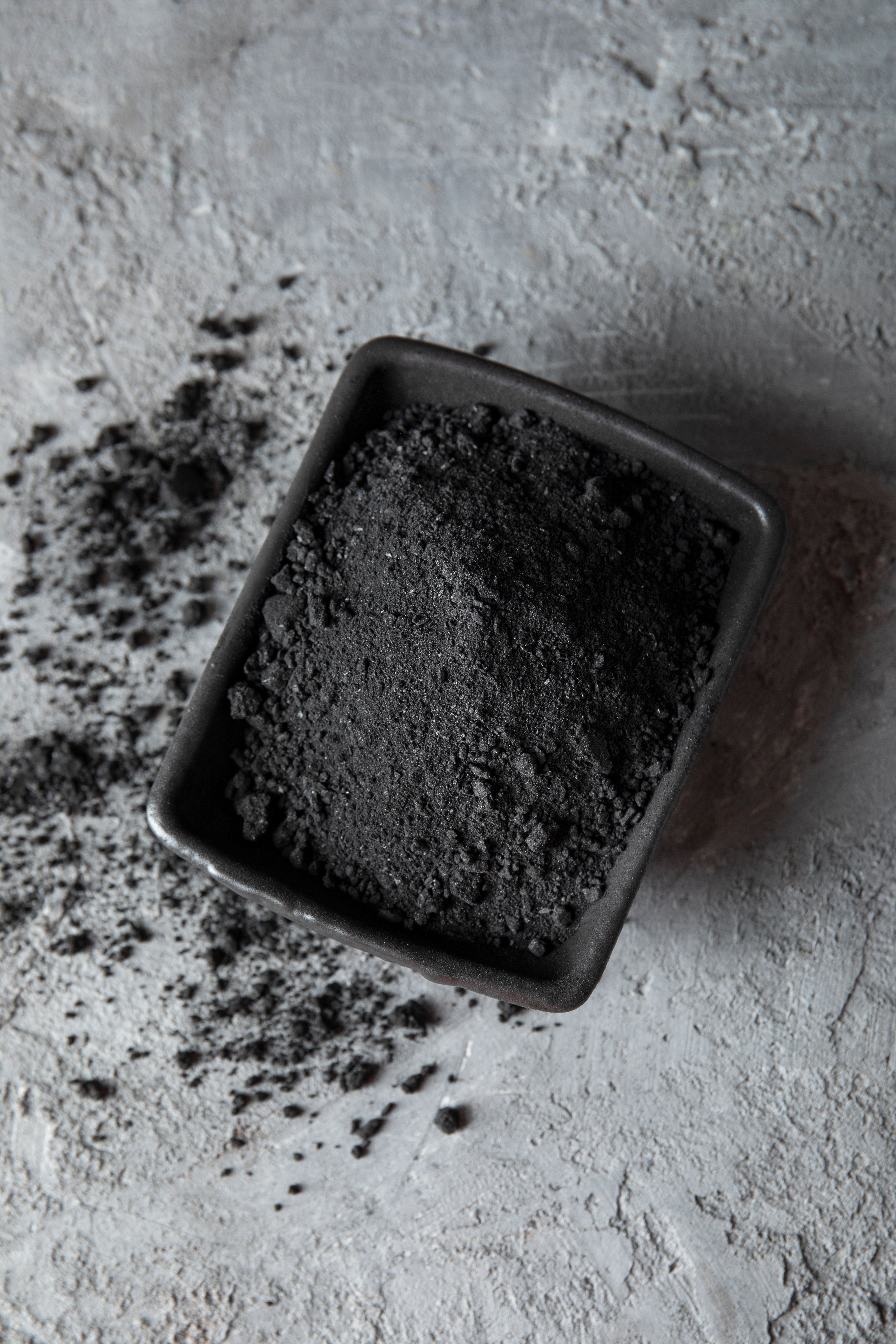 A close-up image of fine ash powder, showcasing its grey color and texture inside a bowl. A close-up image of fine ash powder, showcasing its grey color and texture inside a bowl.
