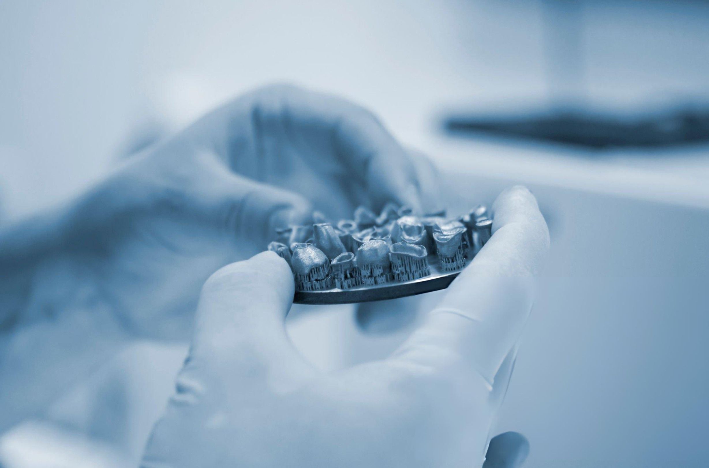 A close-up view of a dental metal coping, showcasing its shiny surface and precise fit for dental restoration procedures.