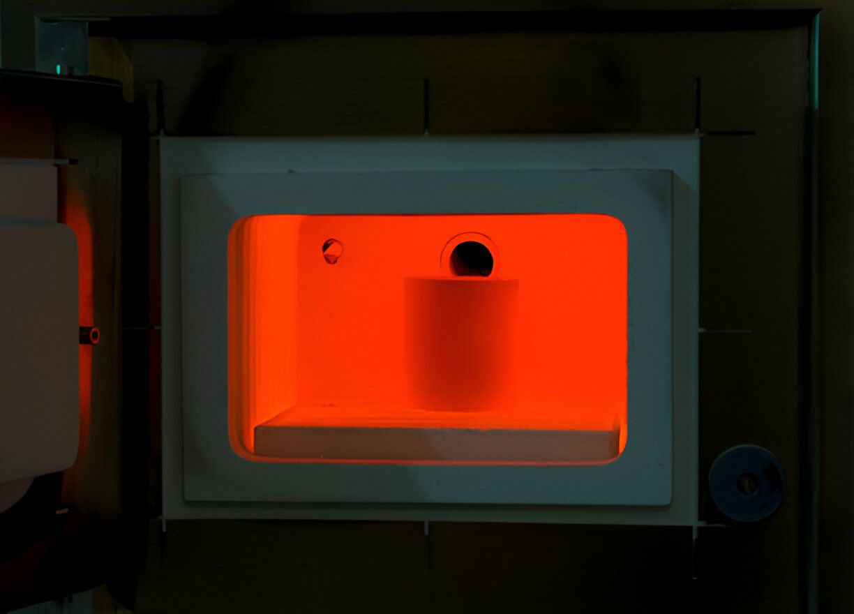 A laboratory furnace actively heating a sample, essential for scientific experiments and material testing