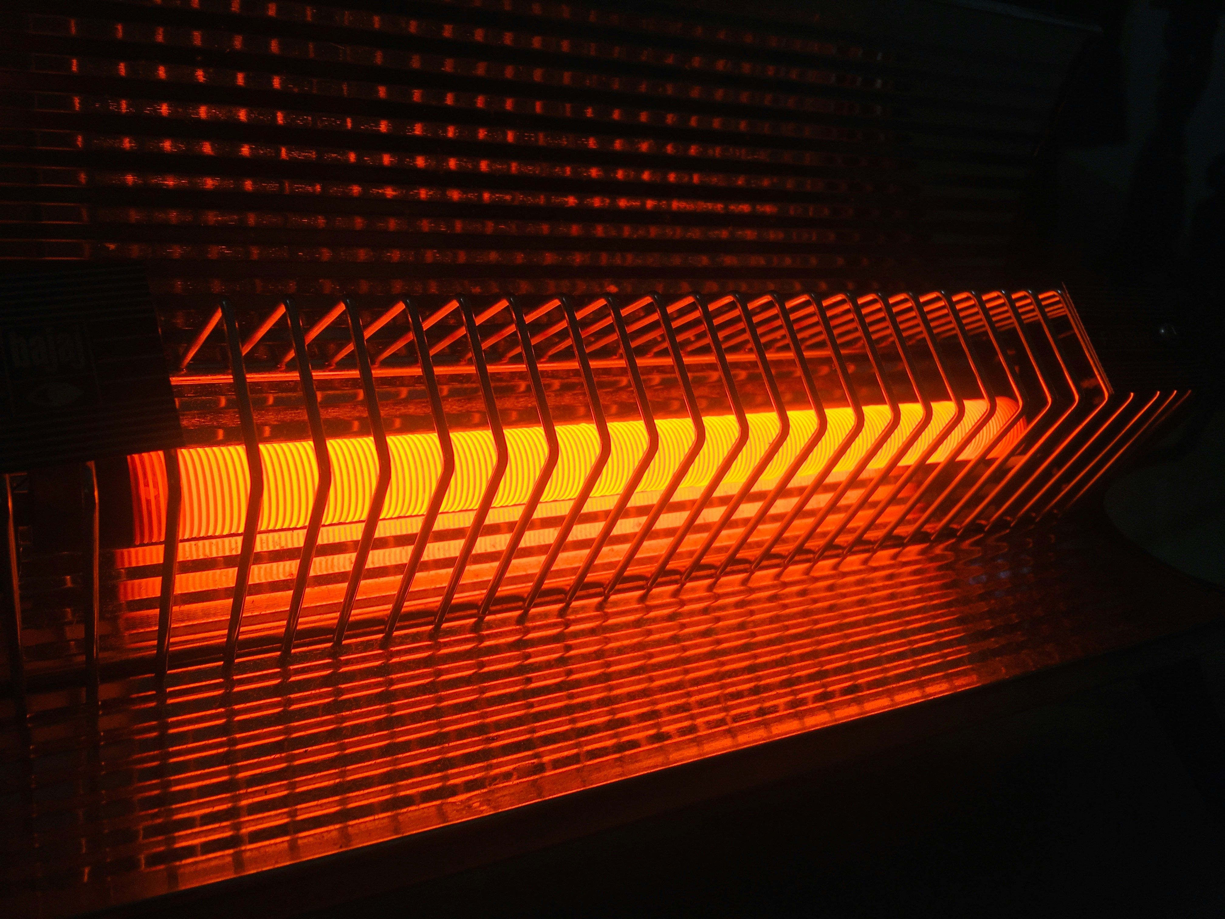 Laboratory furnace heating element emitting heat and light, illustrating its role in experimental processes.
