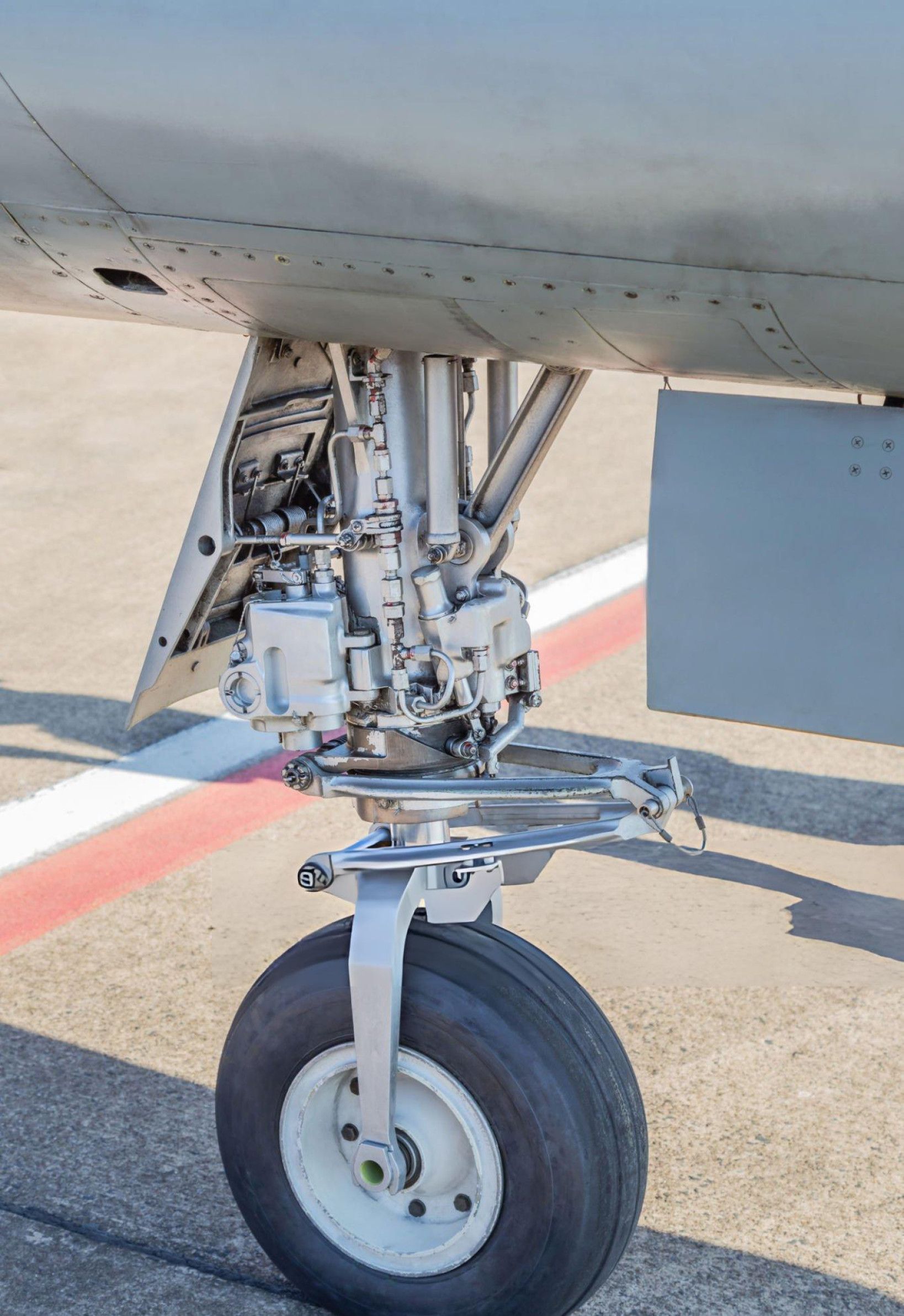 Close-up view of an aircraft's landing gear struts, showcasing their structural design and functionality during landing.