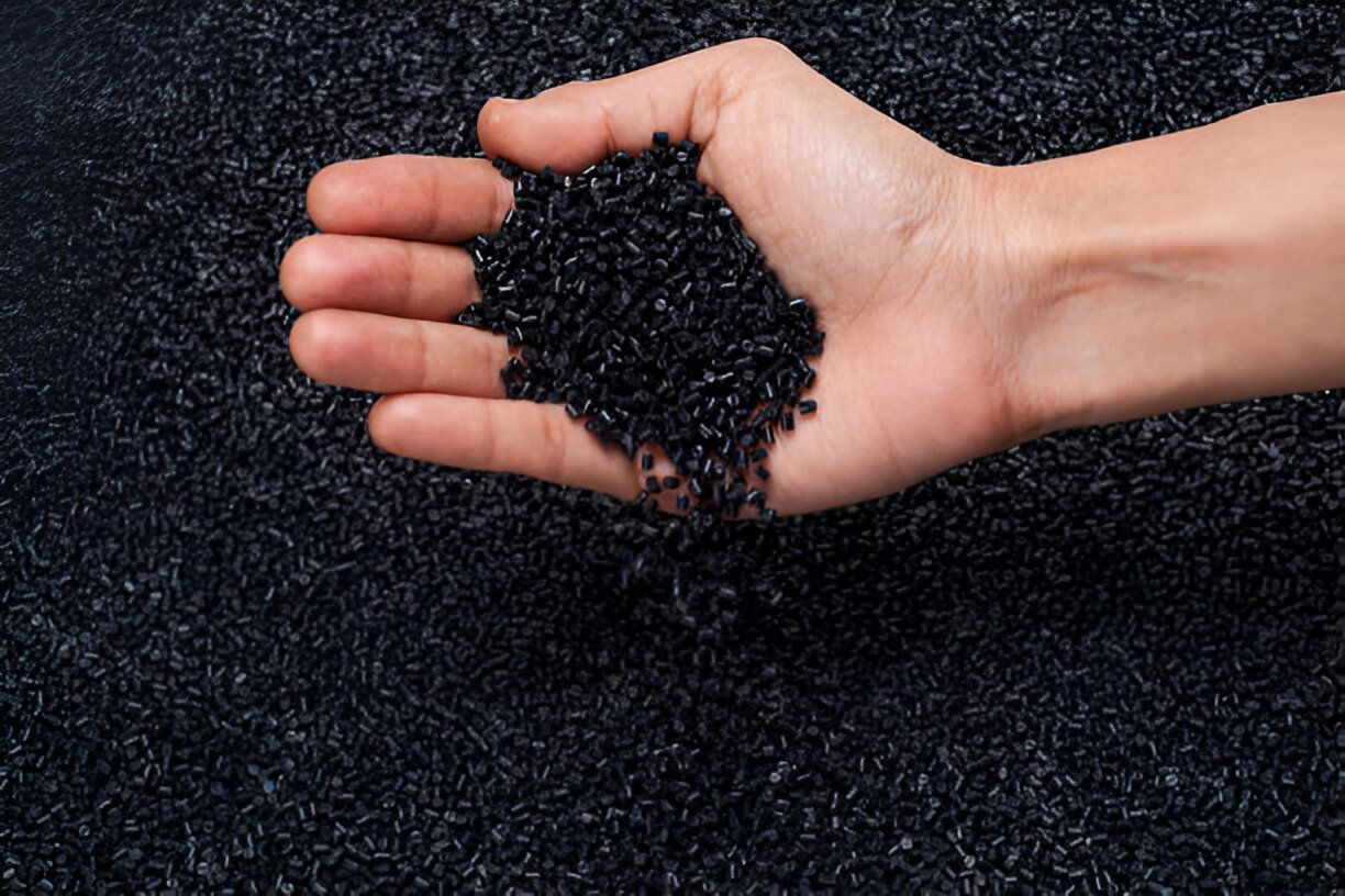  Detailed view of plastic polymer granules laid out uniformly on a smooth surface, highlighting their distinct shapes and sizes