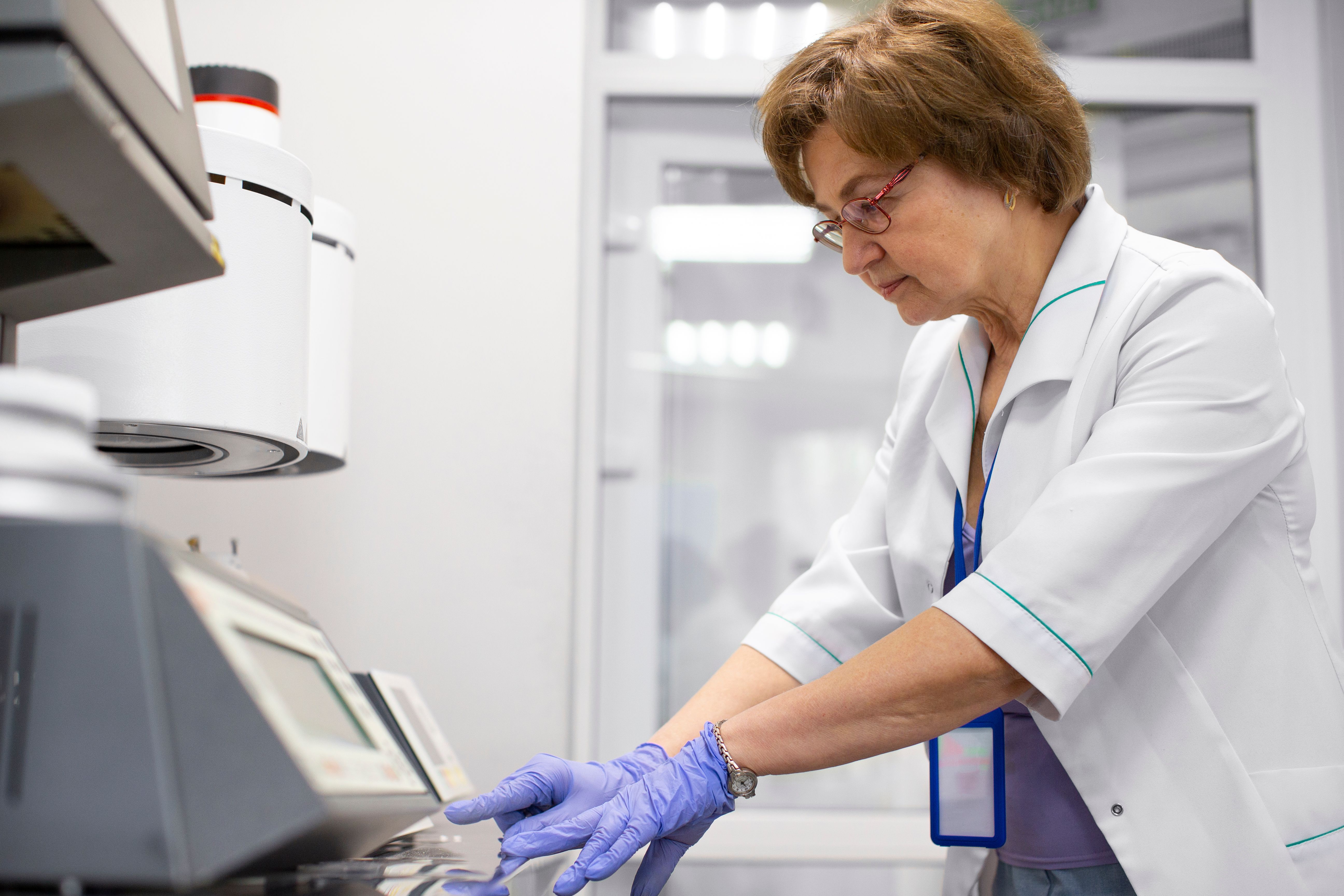 Image of a female lab technician working in a laboratory wearing safety glasses Image of a female lab technician working in a laboratory wearing safety glasses