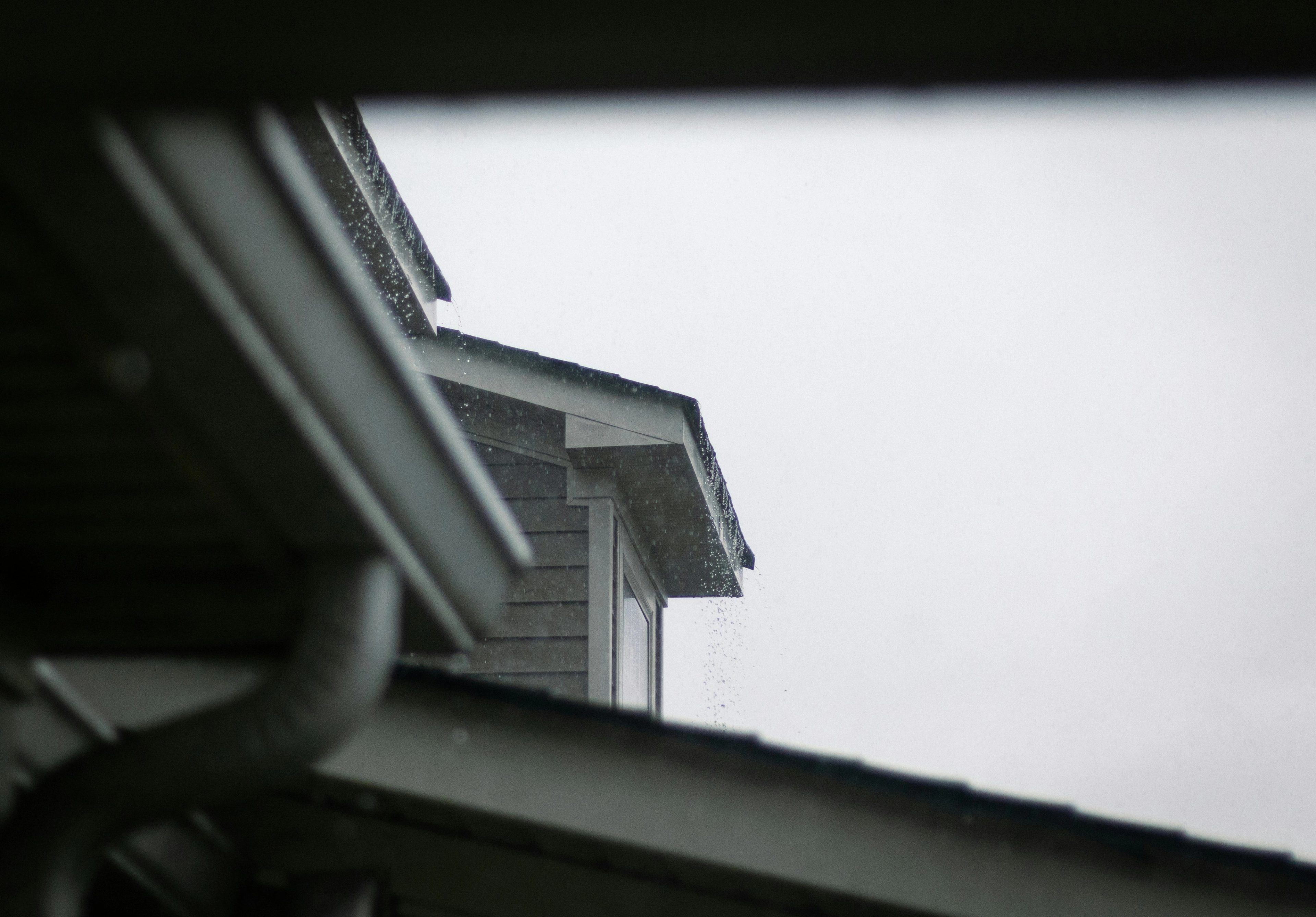 Gutters on the front of a house in the rain