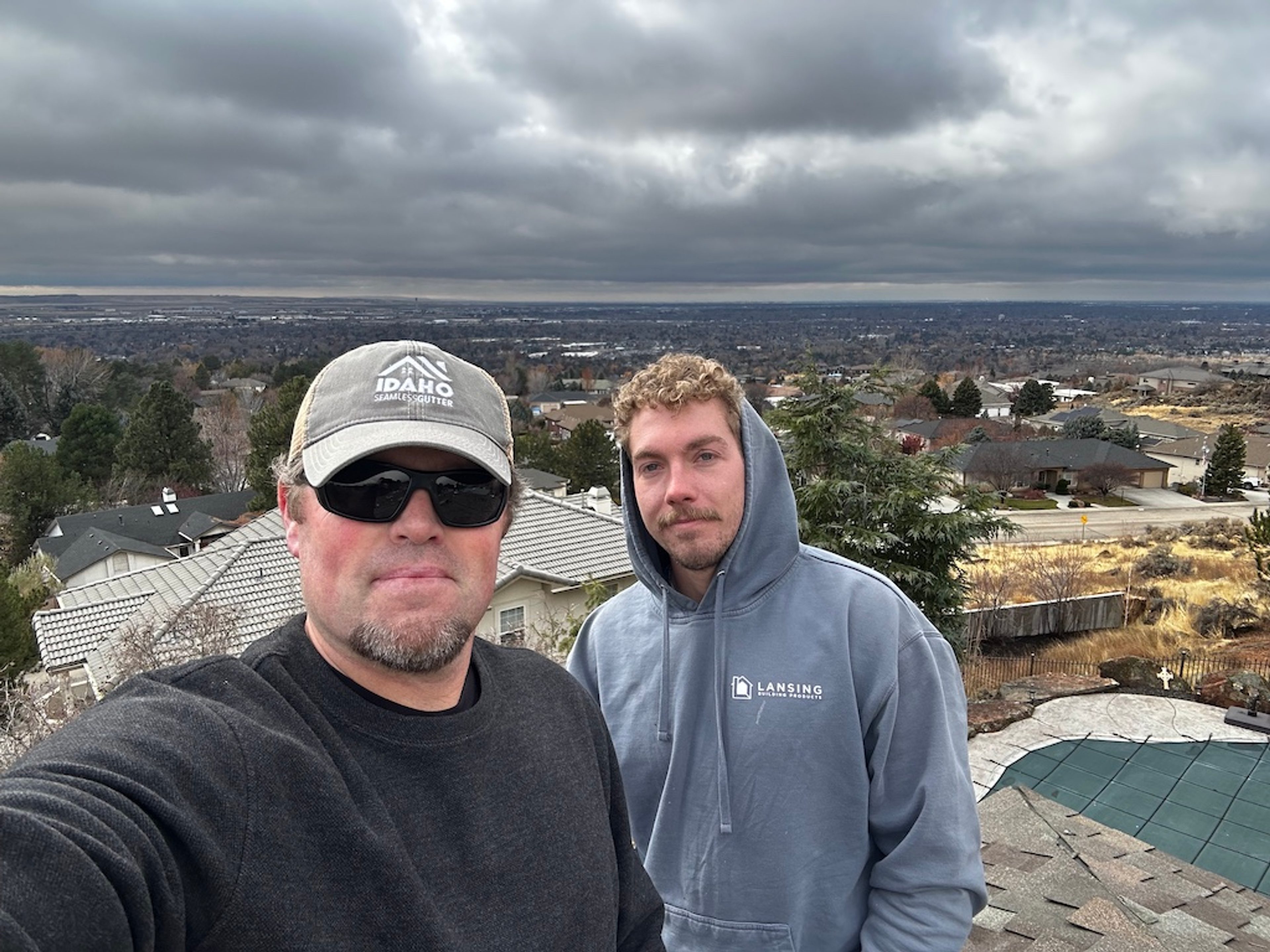 Idaho Seamless Gutter crew overlooking the Boise valley from a rooftop