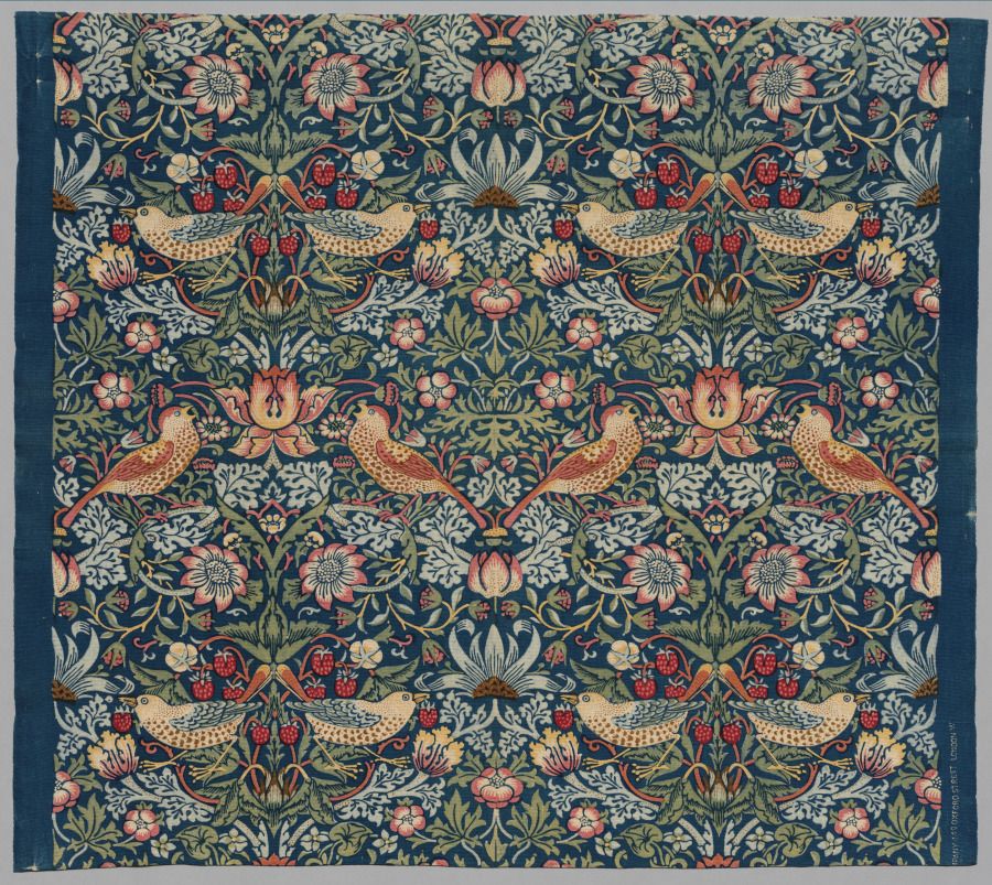 William Morris Strawberry Thief floral textile with birds and flowers on a dark blue ground